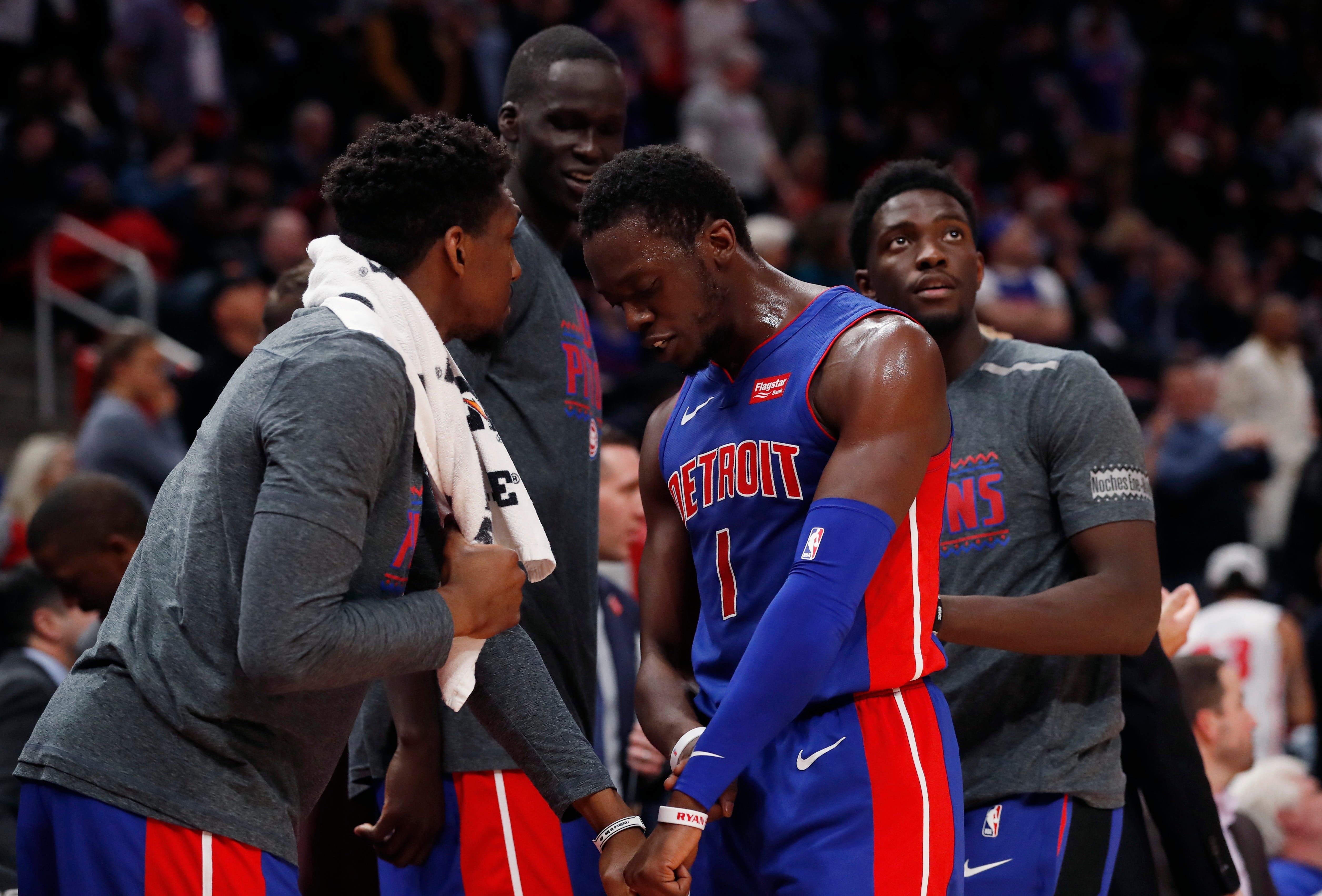 Detroit Pistons guard Langston Galloway, left, greets guard Reggie Jackson during the closing seconds of overtime.