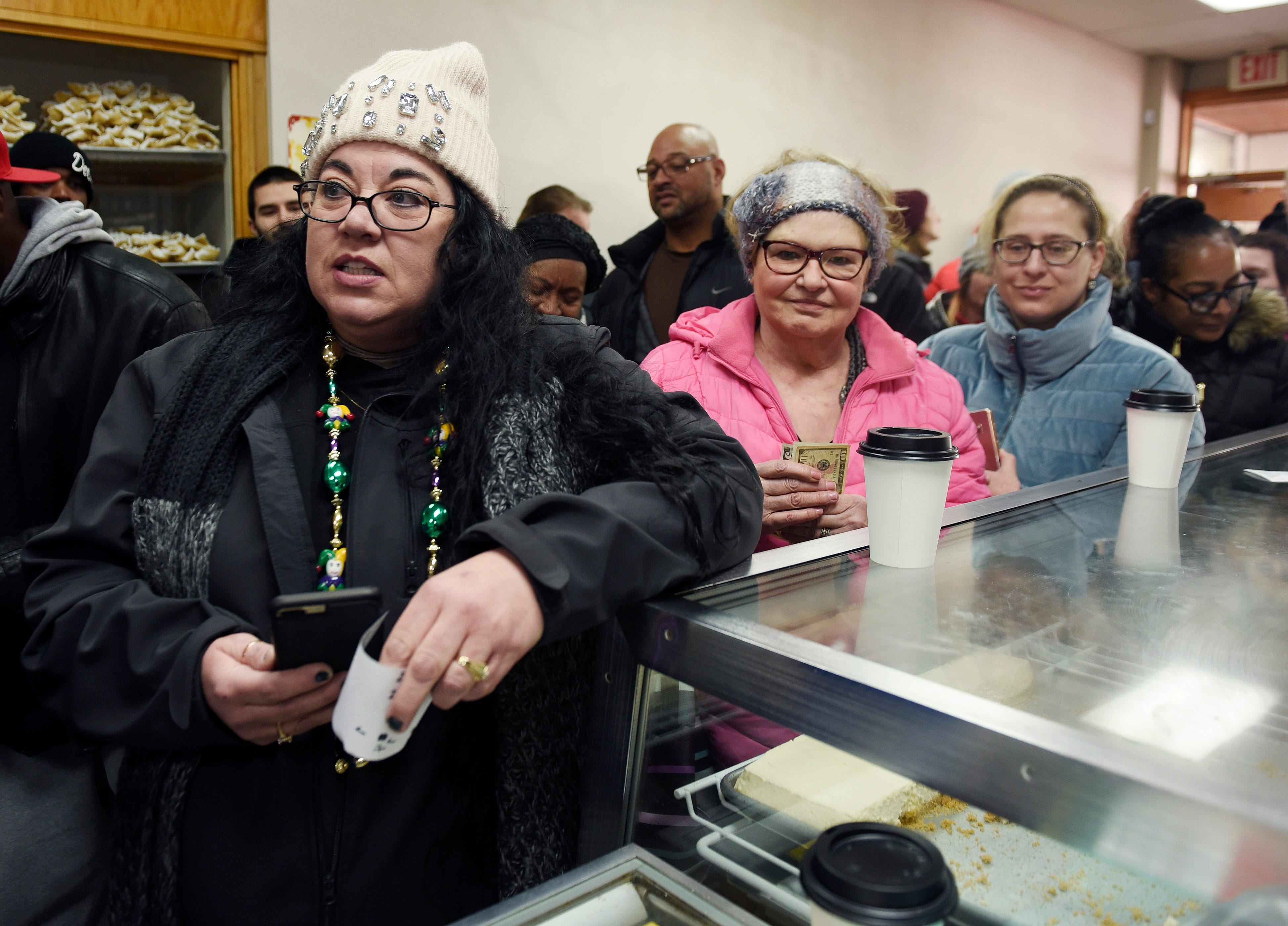Koleen Schaf, (l), of Tayor and Caroline Stokes, (r), of West Bloomfield wait in line to purchase their paczki at New Martha Washington Bakery.