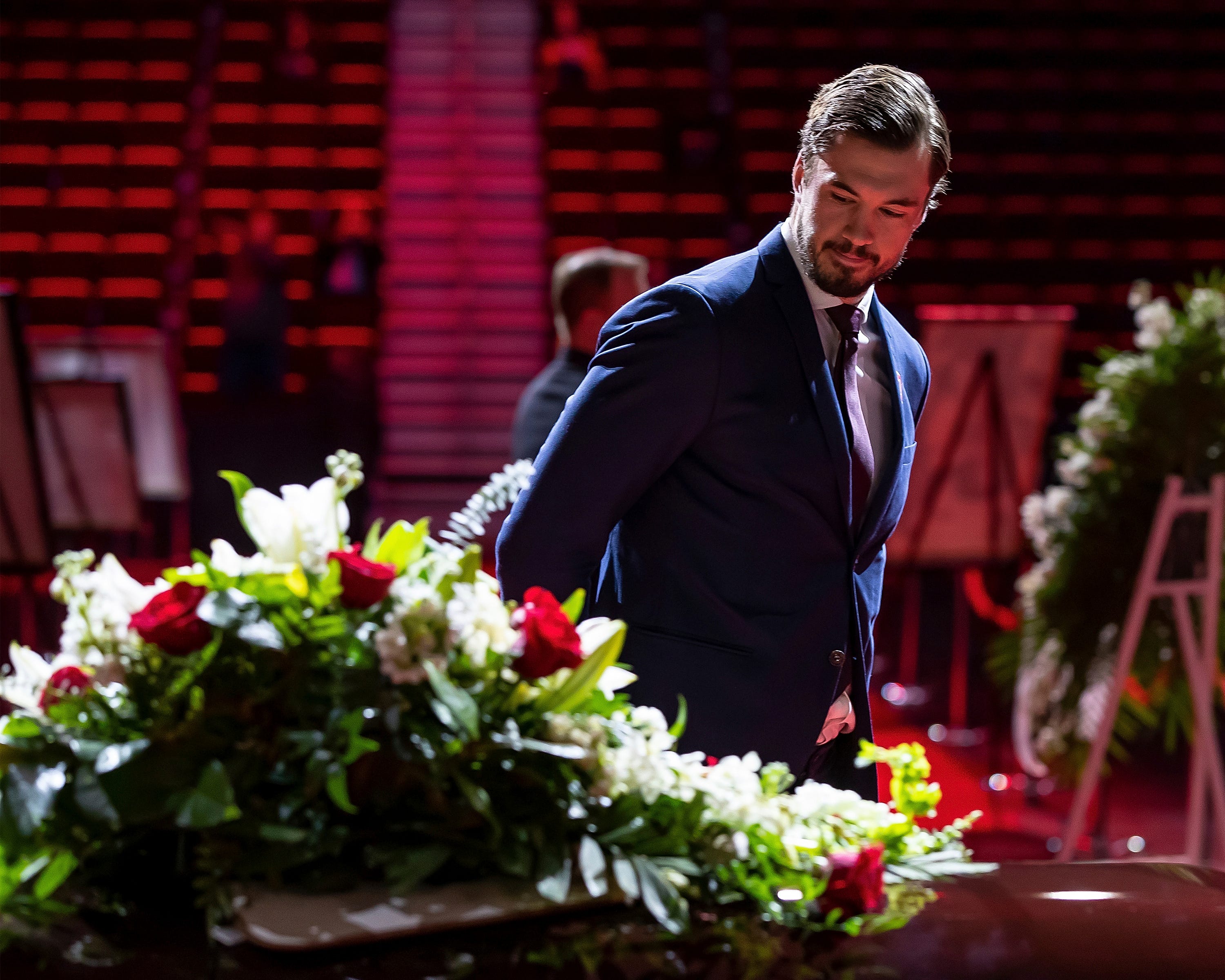 Detroit Red Wings defenseman Jonathan Ericsson views the casket of Ted Lindsay.