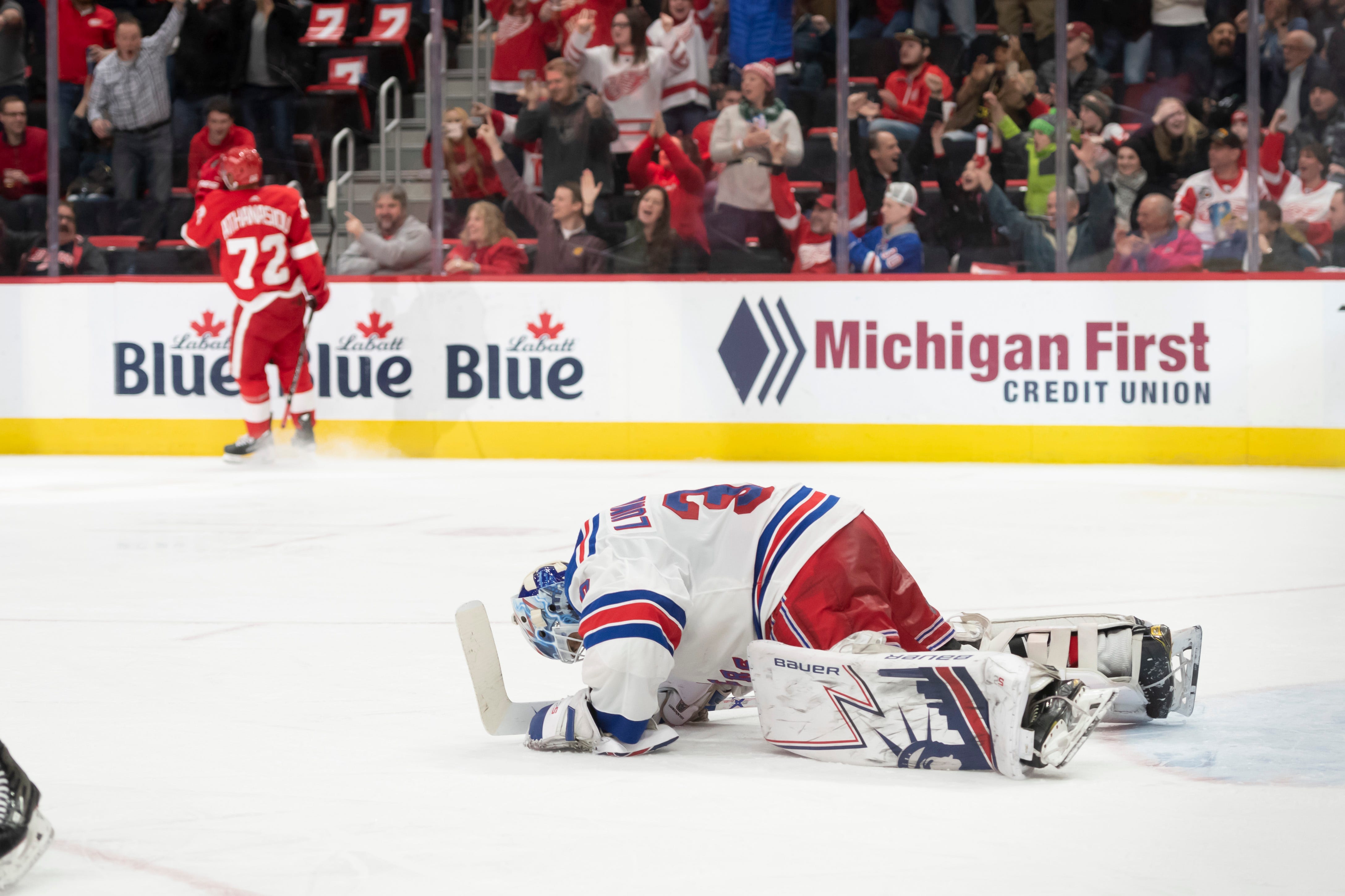 New York goaltender Henrik Lundqvist hits the ice after being scored on by Detroit center Andreas Athanasiou in the third period.