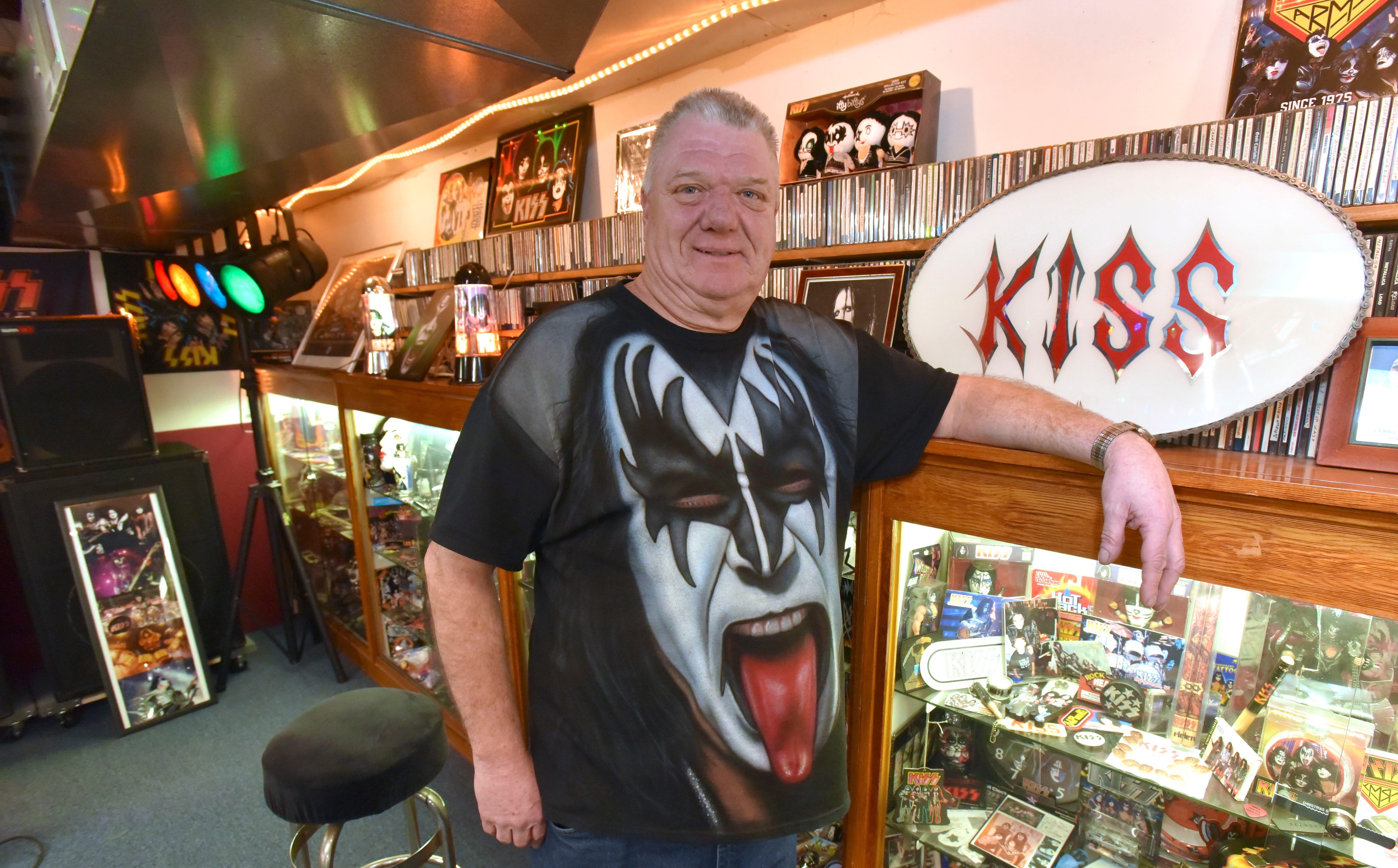 KISS memorabilia collector and fan Terry Pakulski, 58, poses among thousands of KISS items in 14 showcases in his Macomb County basement, Tuesday, March 12, 2019. He's been collecting memorabilia since he was 16. He's been on two KISS cruises and seen KISS 68 times since 1973, attending their concert last Saturday in Grand Rapids. He will attend his 69th KISS concert at Little Caesars Arena Wednesday night as they play their KISS: End of the Road World Tour.