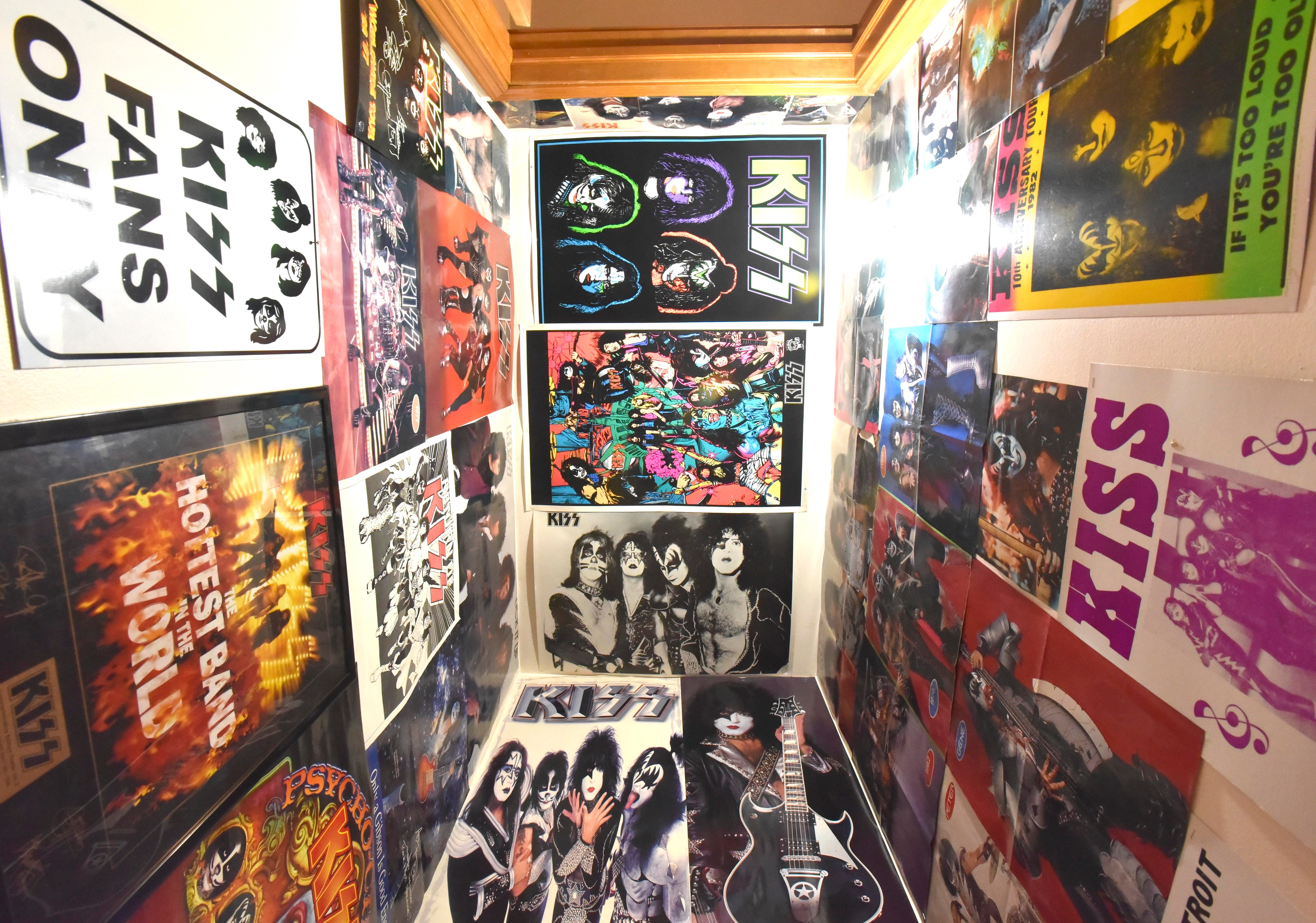 KISS posters are displayed on the staircase walls to the basement.