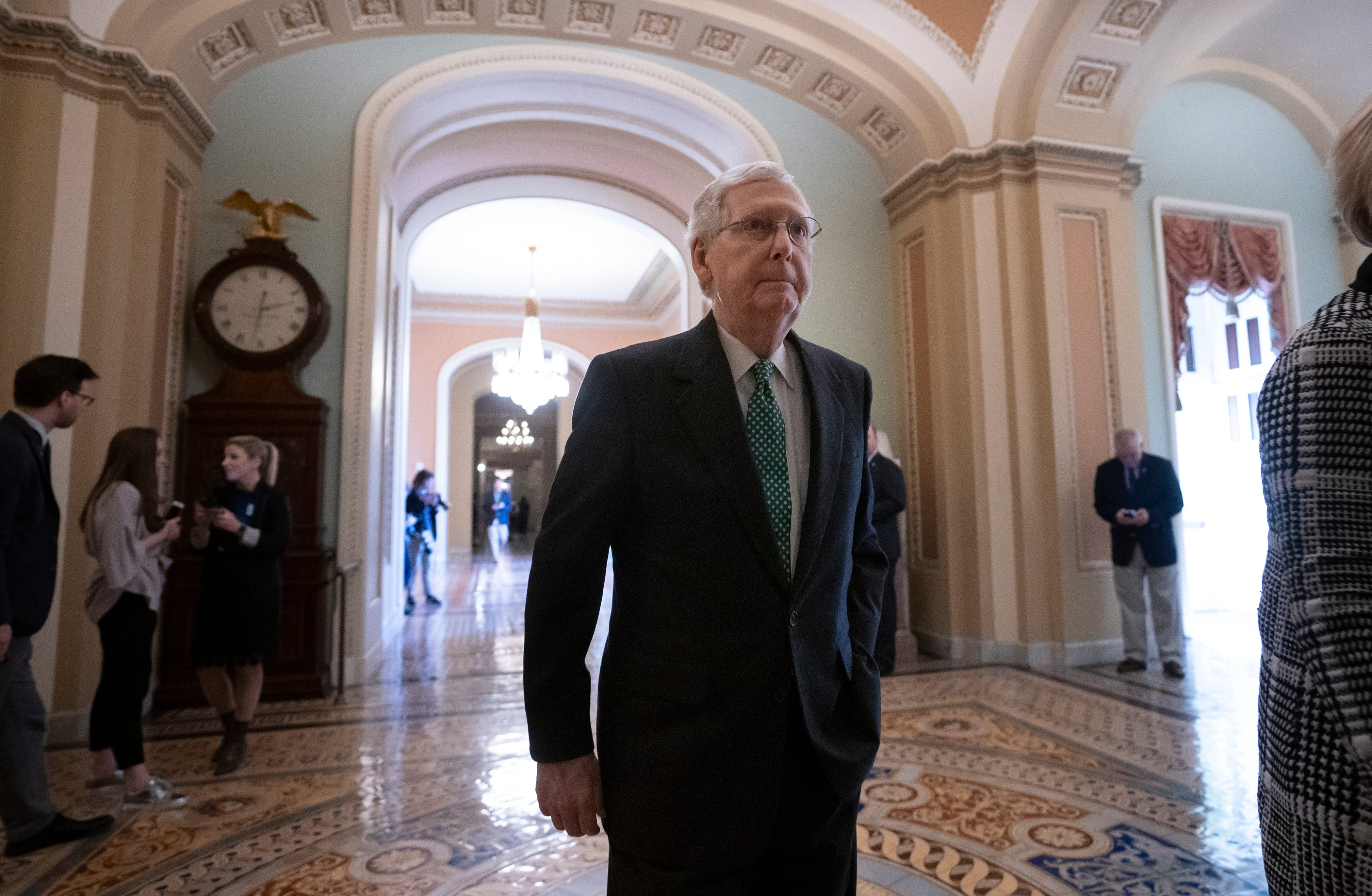 Senate Majority Leader Mitch McConnell, R-Ky., walks to the chamber as the Republican-run Senate rejected President Donald Trump's declaration of a national emergency at the southwest border, at the Capitol in Washington, Thursday, March 14, 2019.