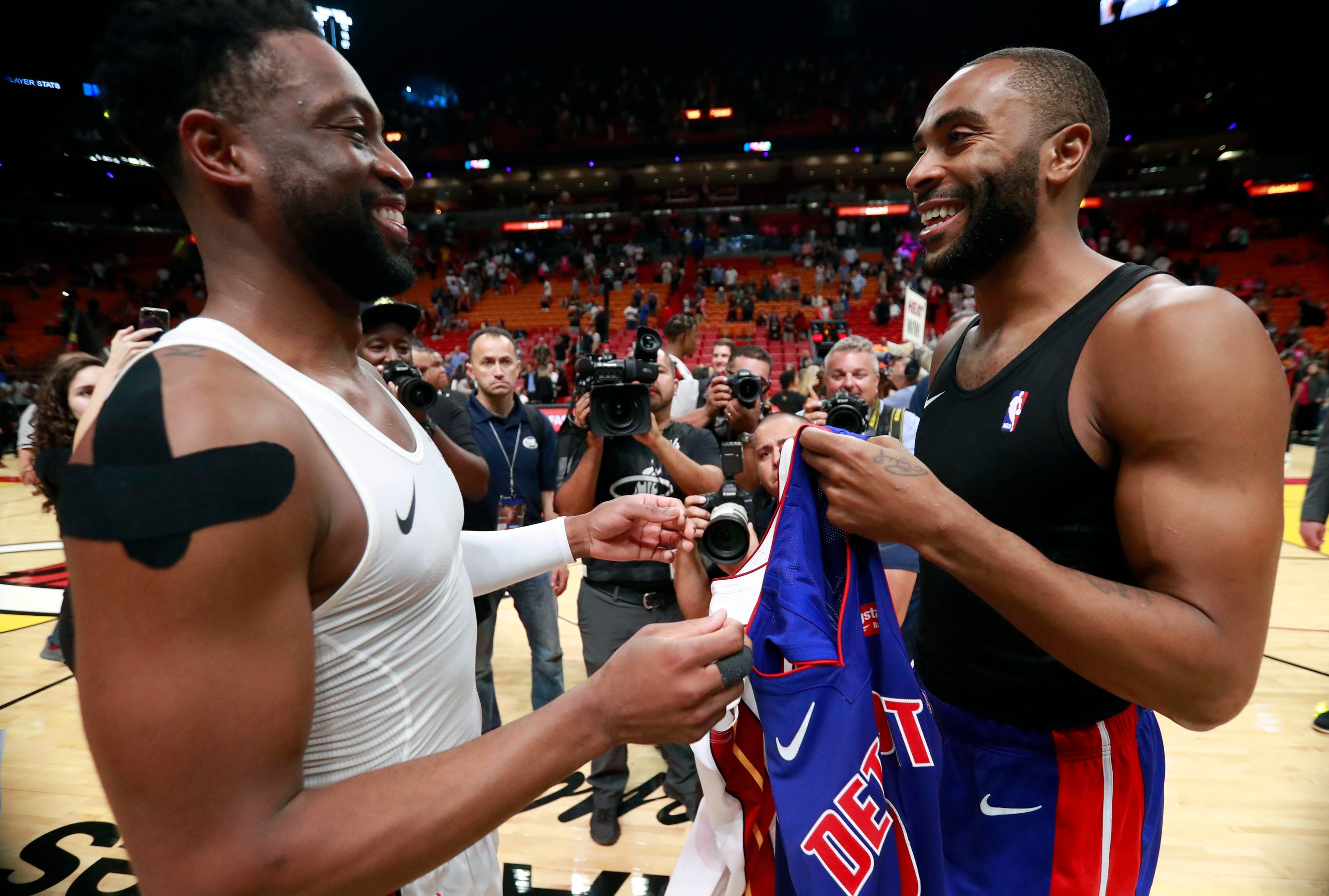 Miami Heat guard Dwyane Wade, left, and Detroit Pistons guard Wayne Ellington smile as they exchange jerseys after the game.