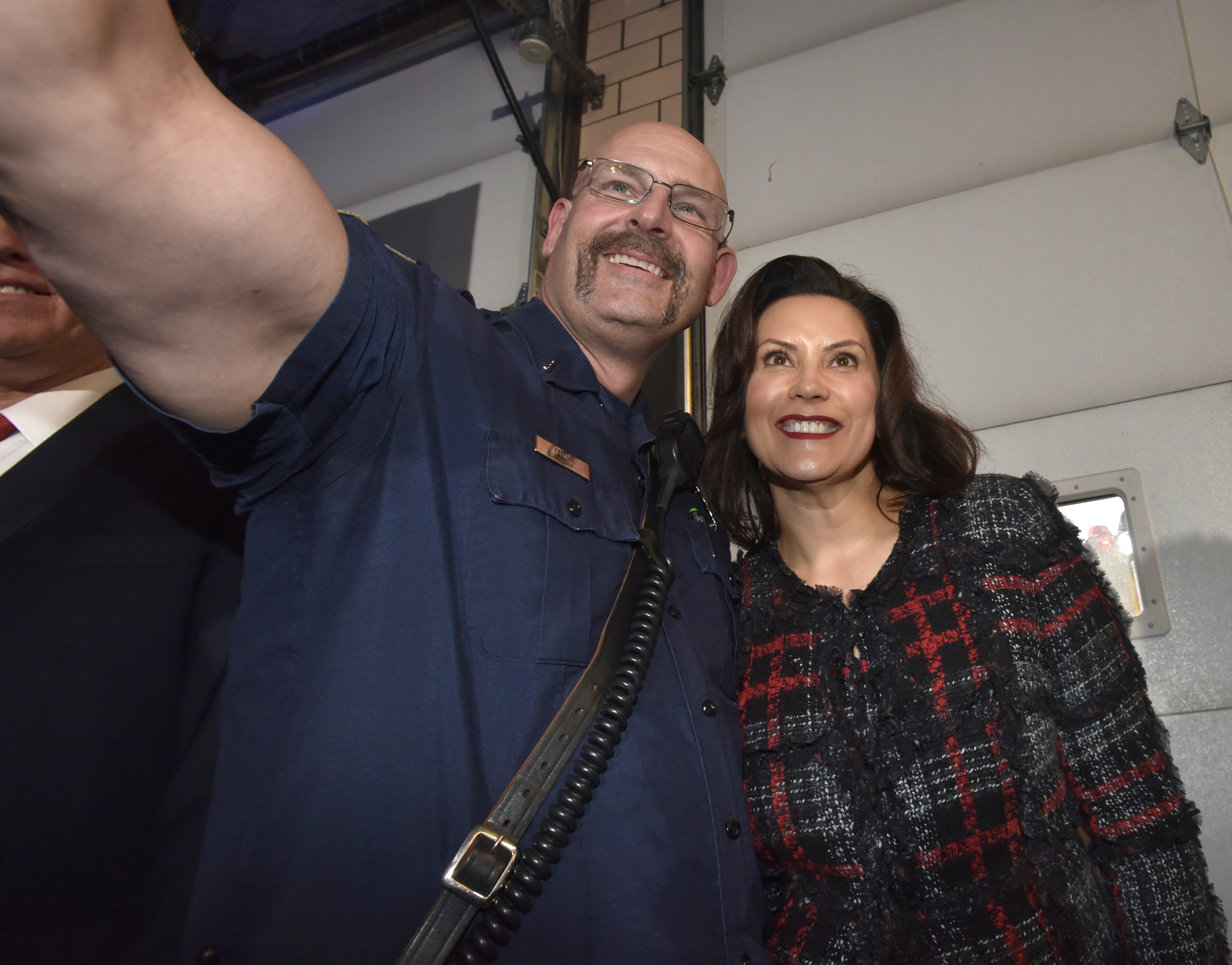 Eastpointe Fire Lt. Kirk Lee, left, takes a selfie with Michigan Governor Gretchen Whitmer after the press conference.