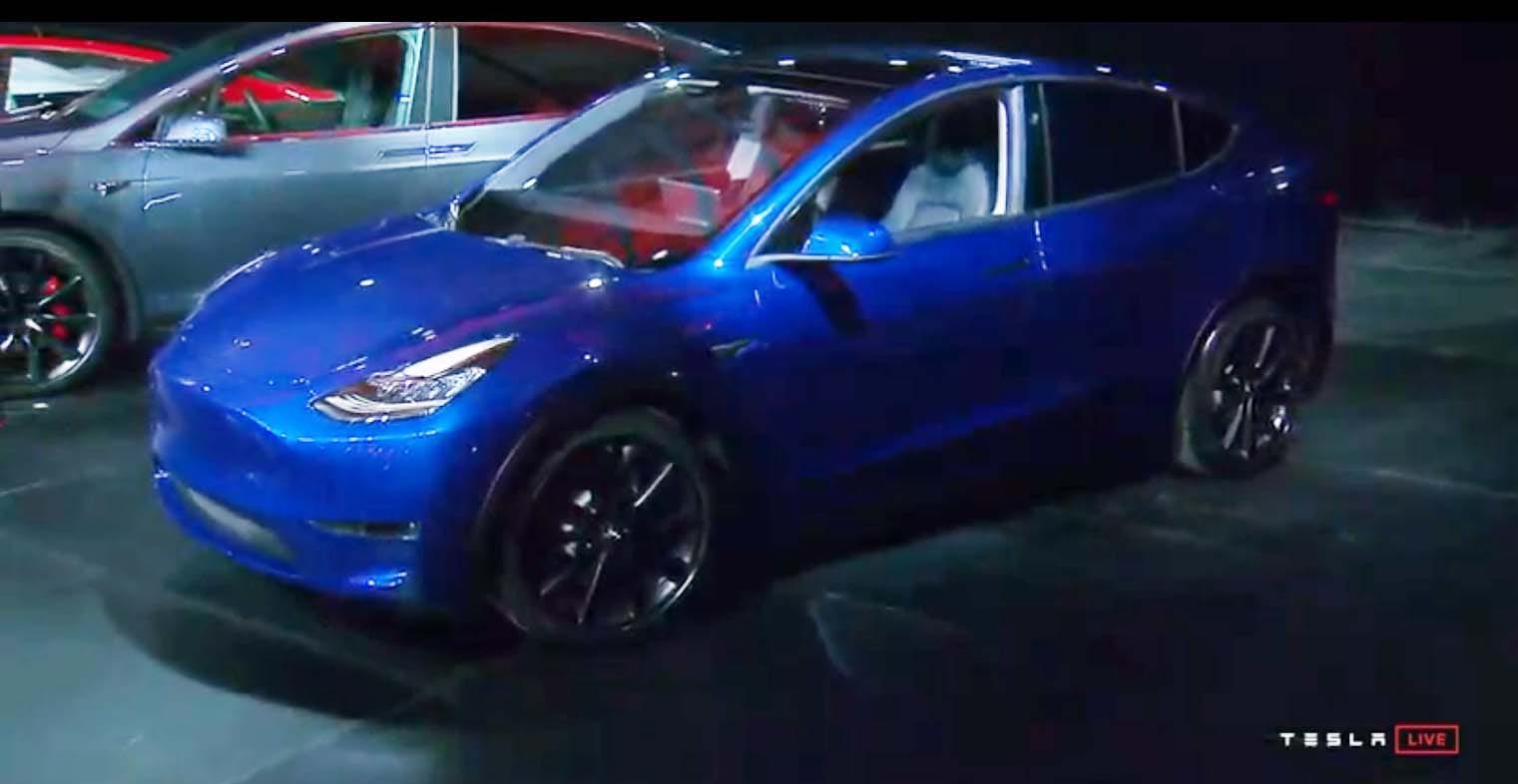 At alst. The Tesla Model Y SUV gets its debut at the EV brand's LA design studio just before midnight EST Thursday.