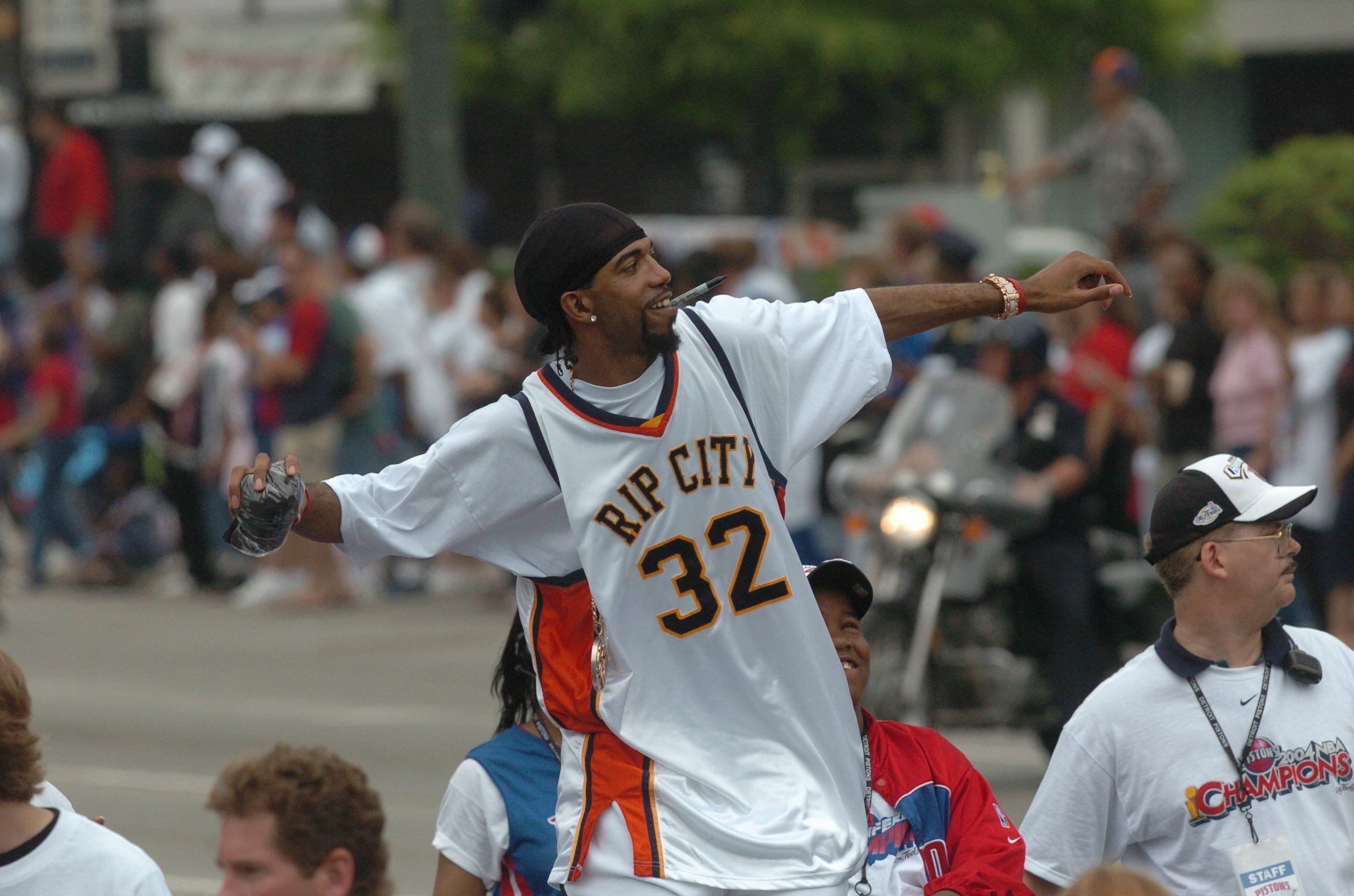 Detroit's Richard Hamilton tosses one of many personally-signed T-shirts into the crowd during the Detroit Pistons victory parade.