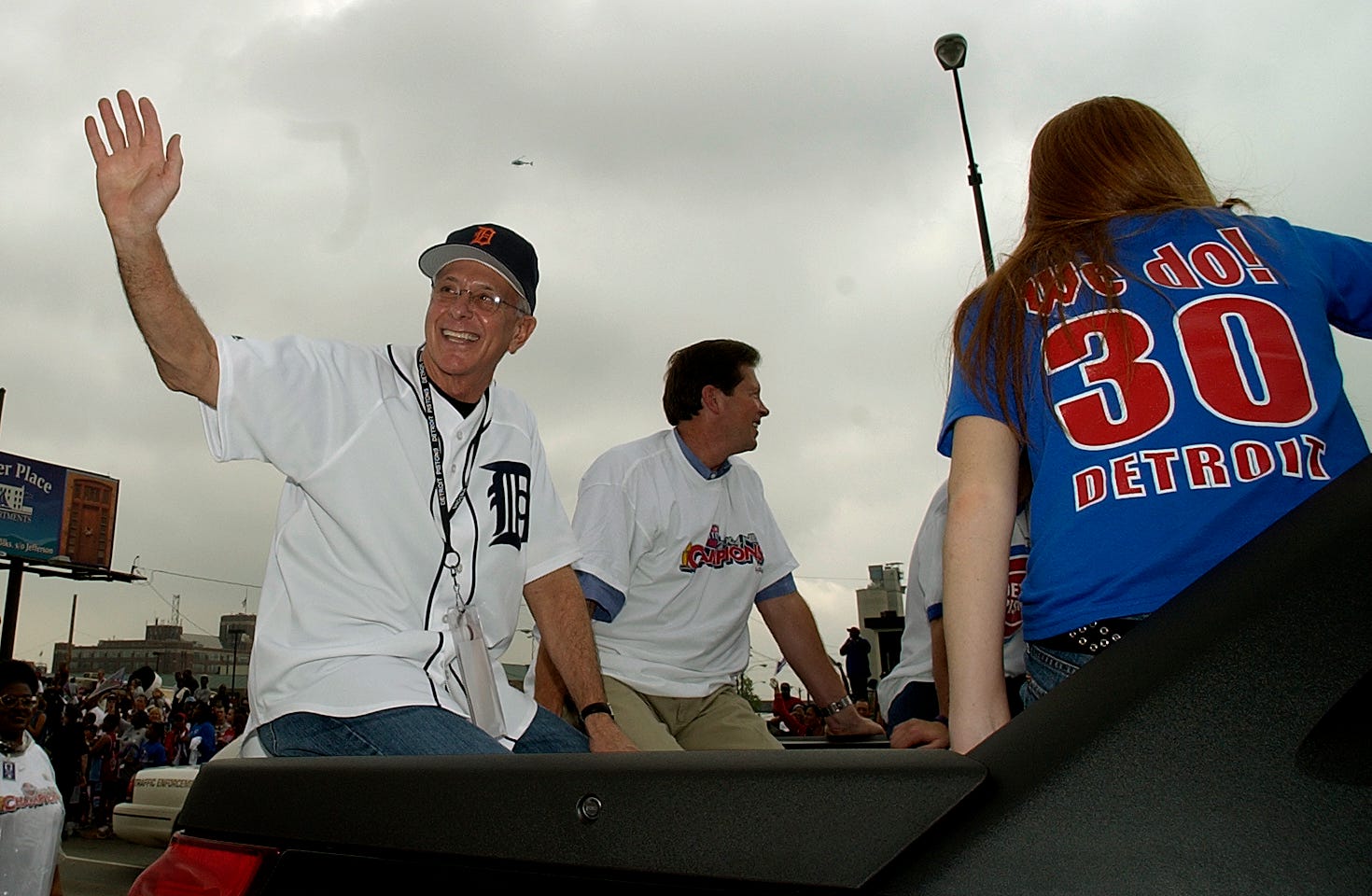 Pistons head coach Larry Brown, left, waves to the crowd with Tom Wilson, head of Palace Entertainment, during the parade. Thursday, June 17, 2004.