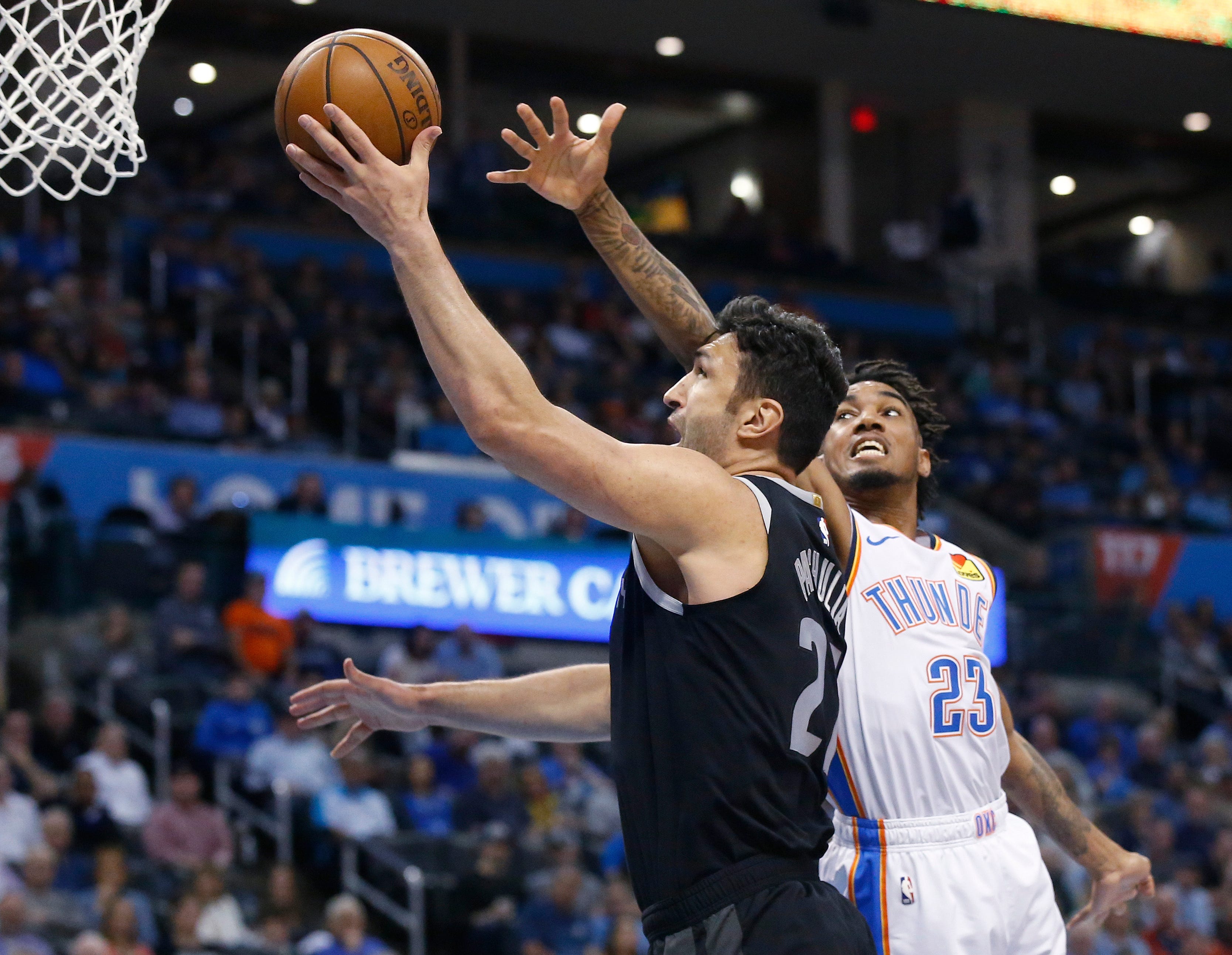 Detroit Pistons center Zaza Pachulia, left, shoots in front of Oklahoma City Thunder guard Terrance Ferguson (23) during the first half.