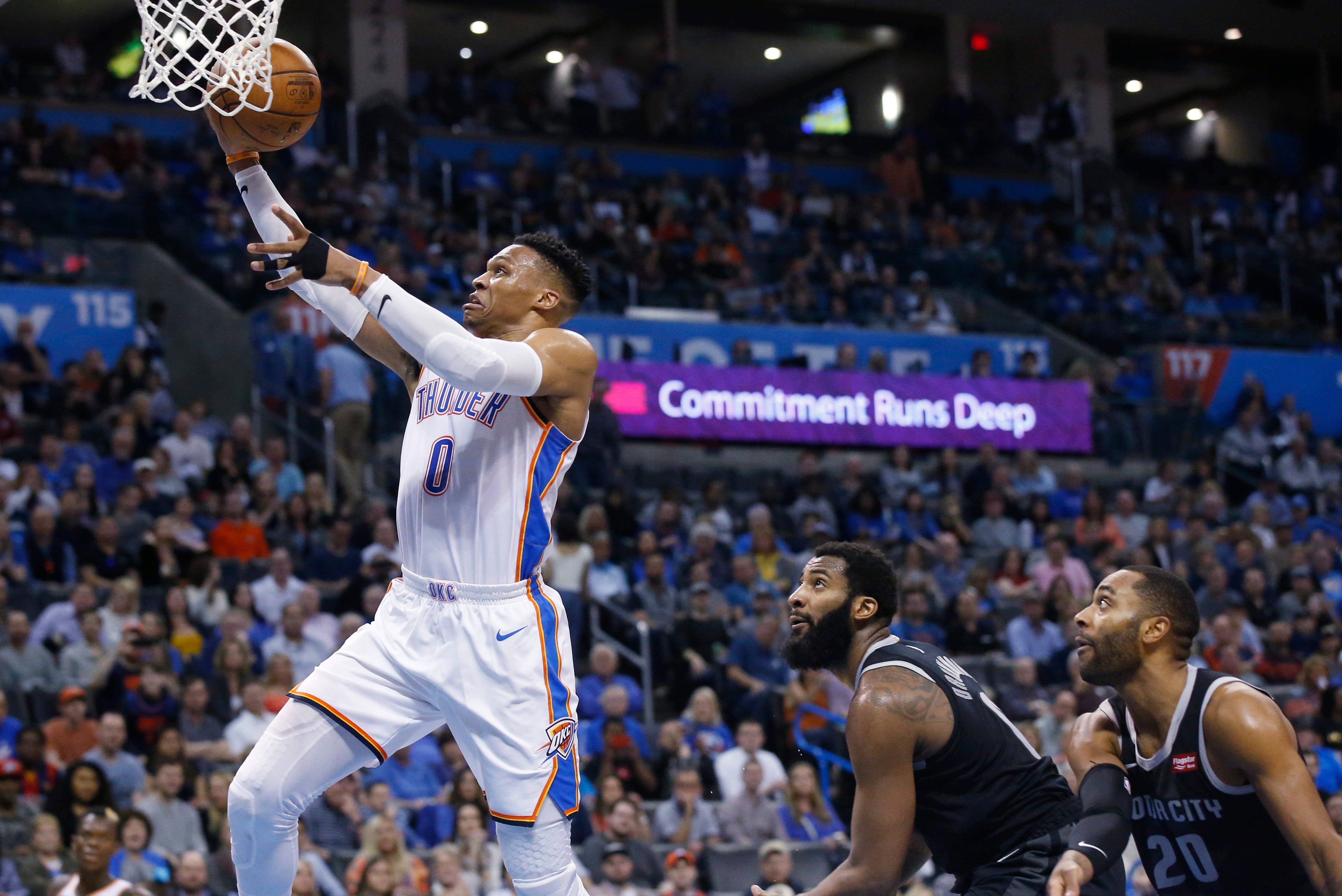 Oklahoma City Thunder guard Russell Westbrook (0) goes to the basket in front of Detroit Pistons center Andre Drummond, center, and guard Wayne Ellington (20) during the second half.