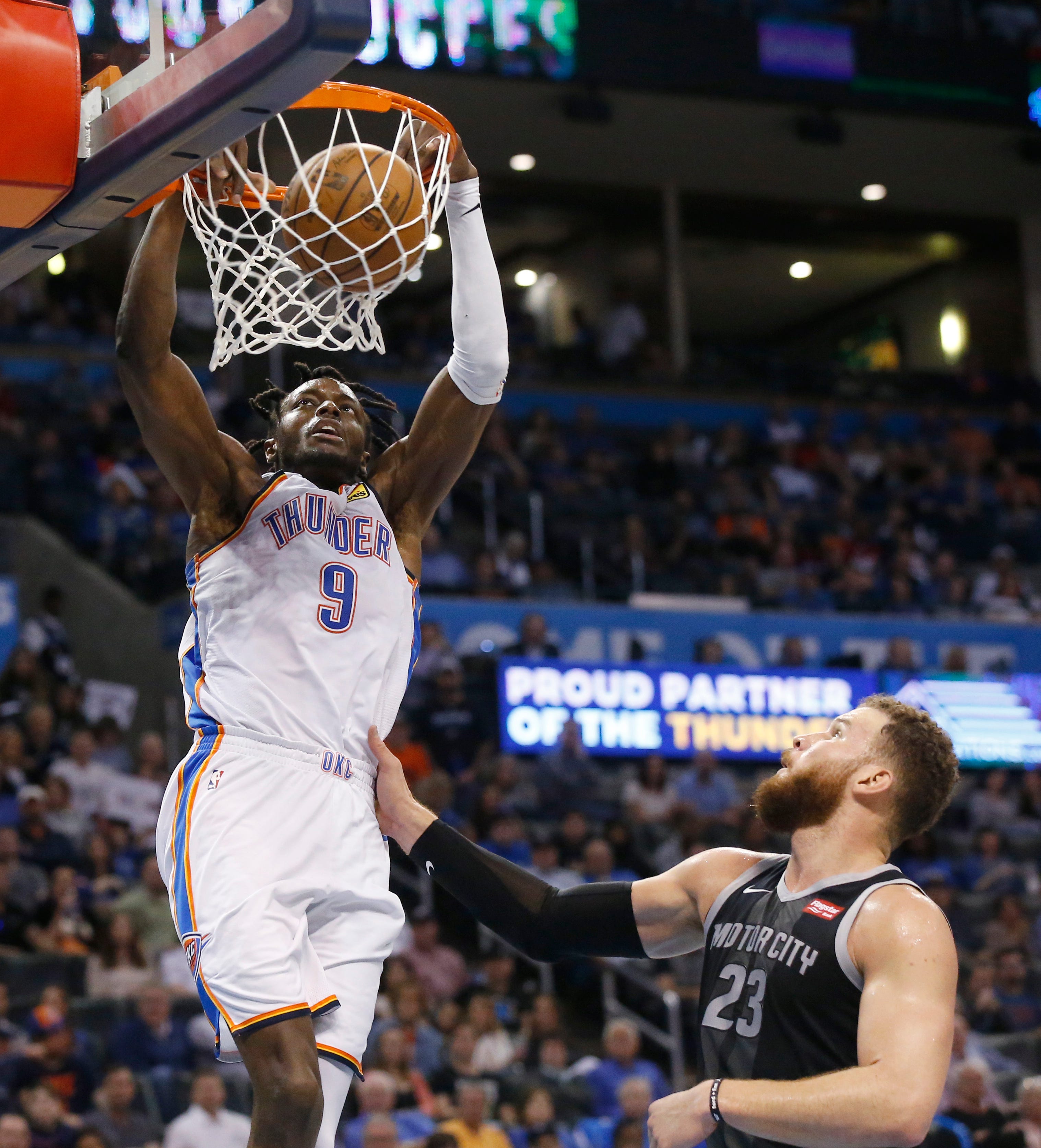 Oklahoma City Thunder forward Jerami Grant (9) dunks in front of Detroit Pistons forward Blake Griffin (23) during the second half of an NBA basketball game Friday, April 5, 2019, in Oklahoma City.  The Thunder defeated the Pistons 123-110.