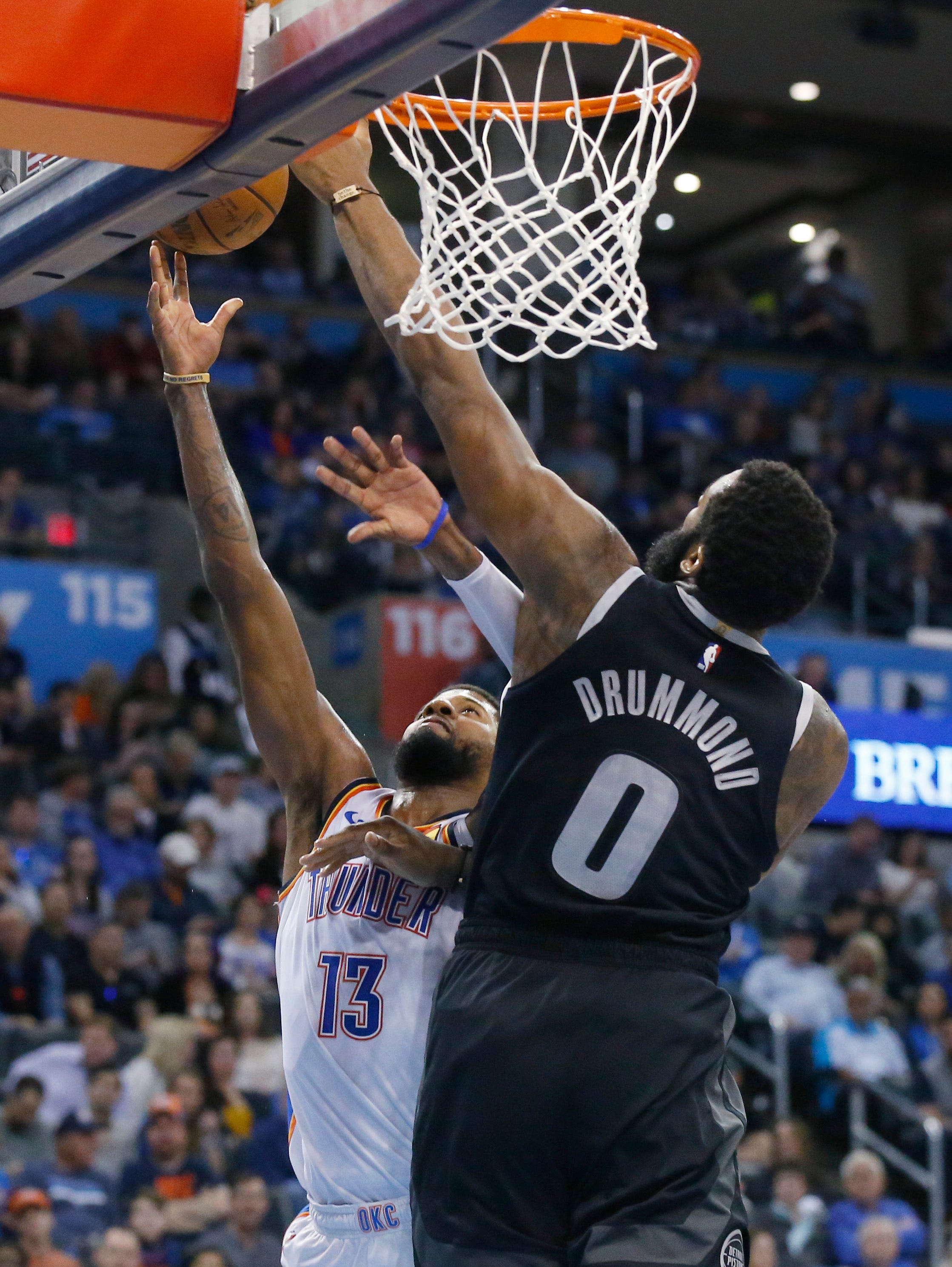 Oklahoma City Thunder forward Paul George (13) shoots as Detroit Pistons center Andre Drummond (0) defends during the second half.