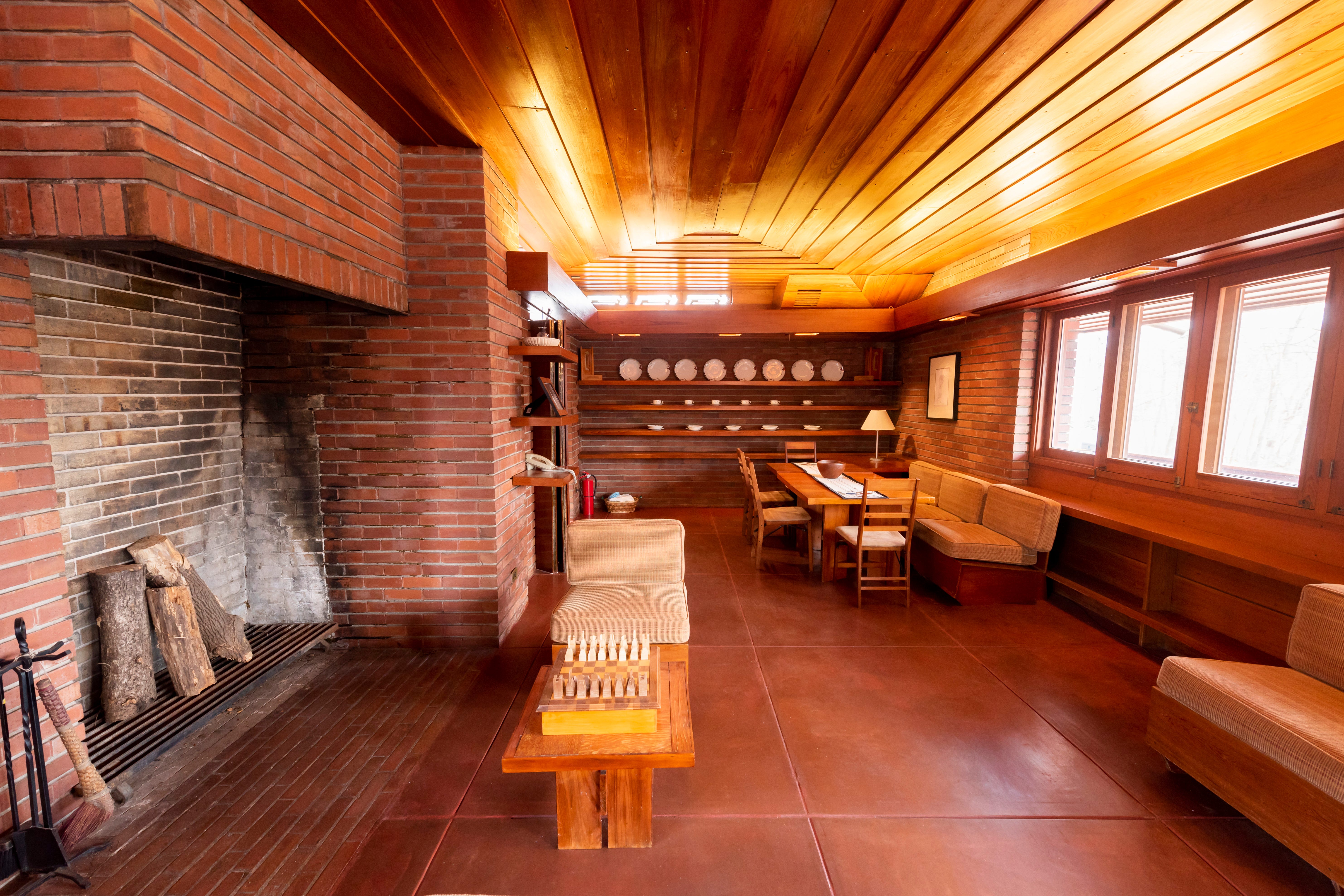 The main living area included a six-foot-high fireplace designed to hold tall logs vertically.
