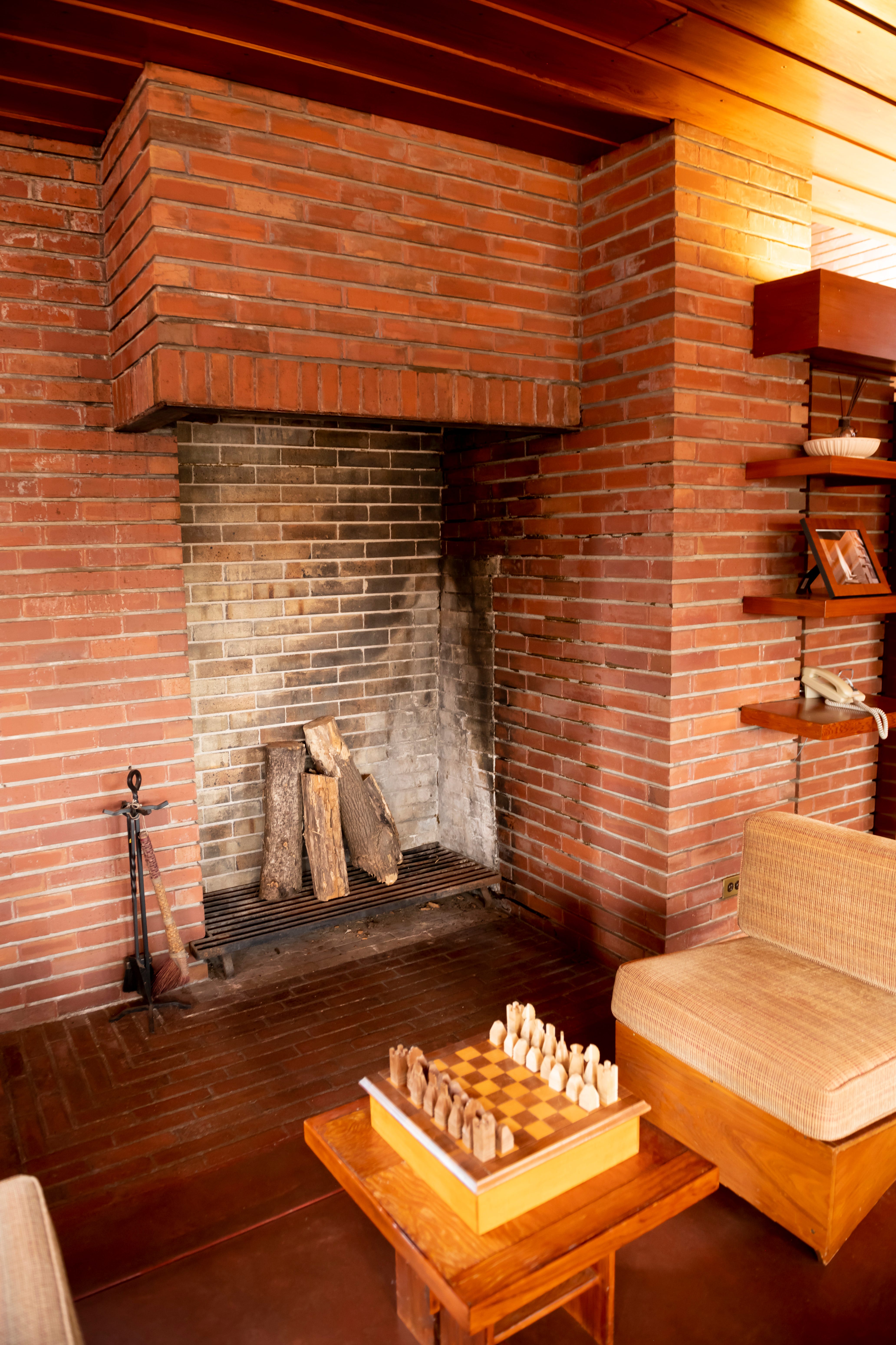 The main living area included a 6-foot-high fireplace designed to hold tall logs vertically.