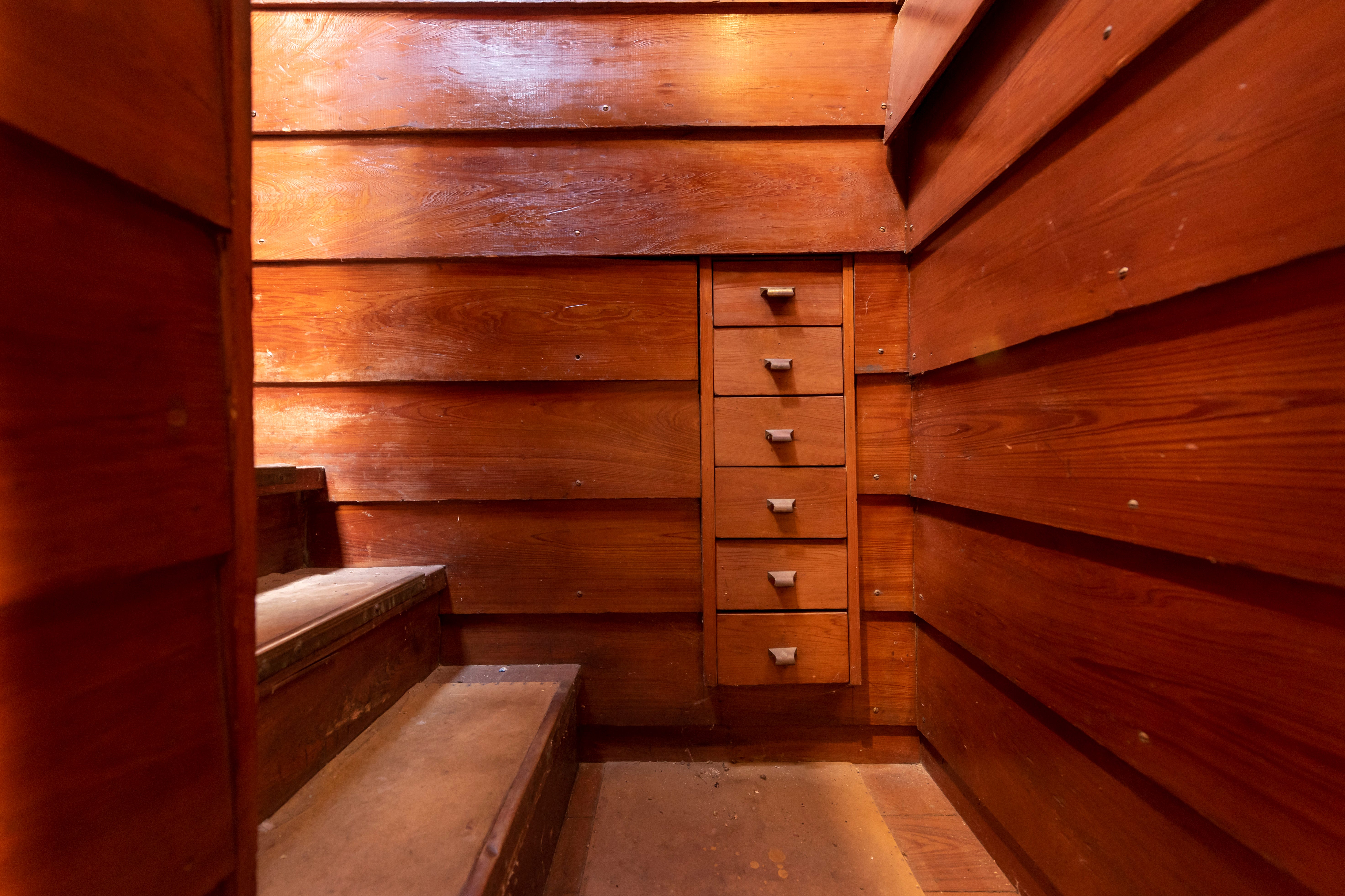 Storage drawers built into the stairwell leading to the basement.