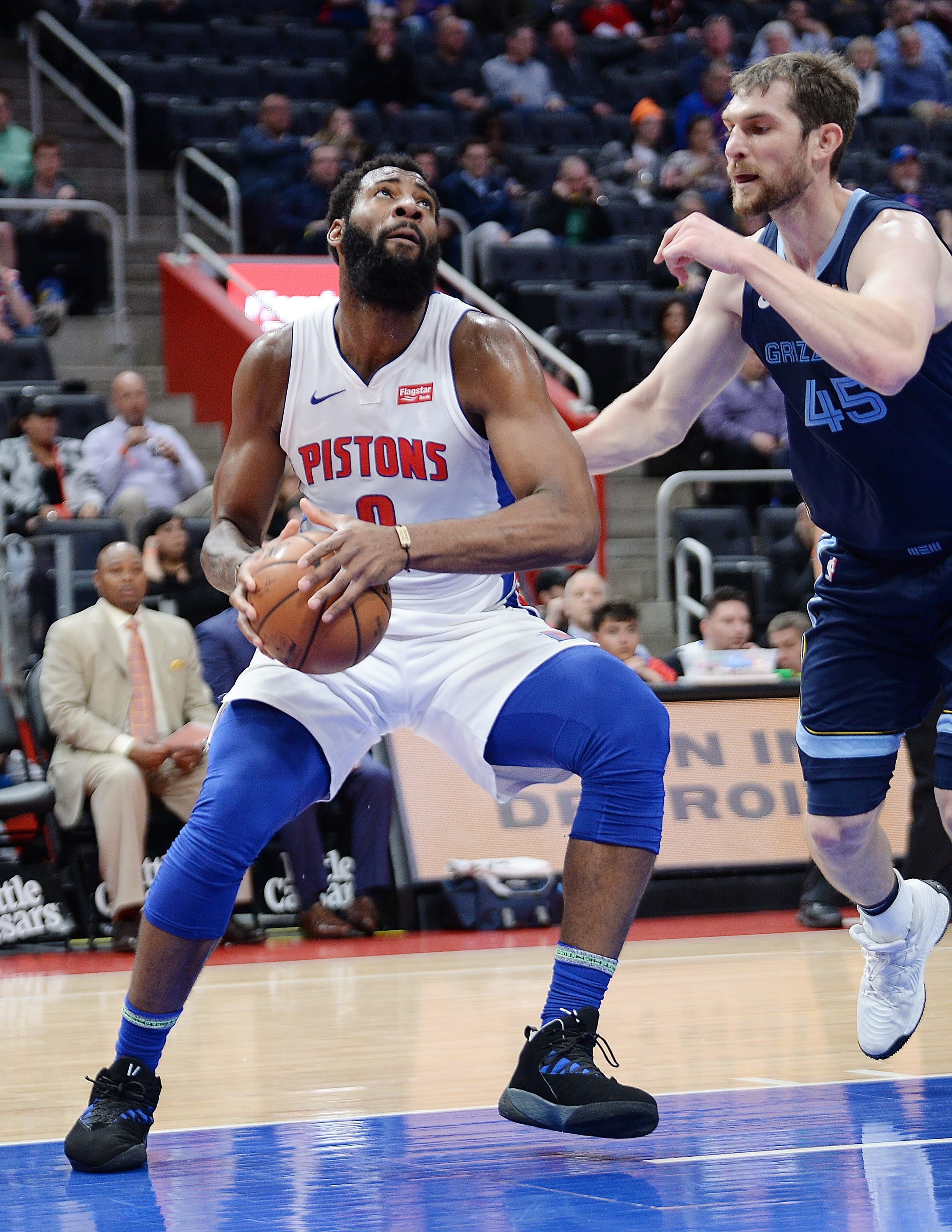 Pistons' Andre Drummond drives around Grizzlies' Tyler Zeller in the first quarter.