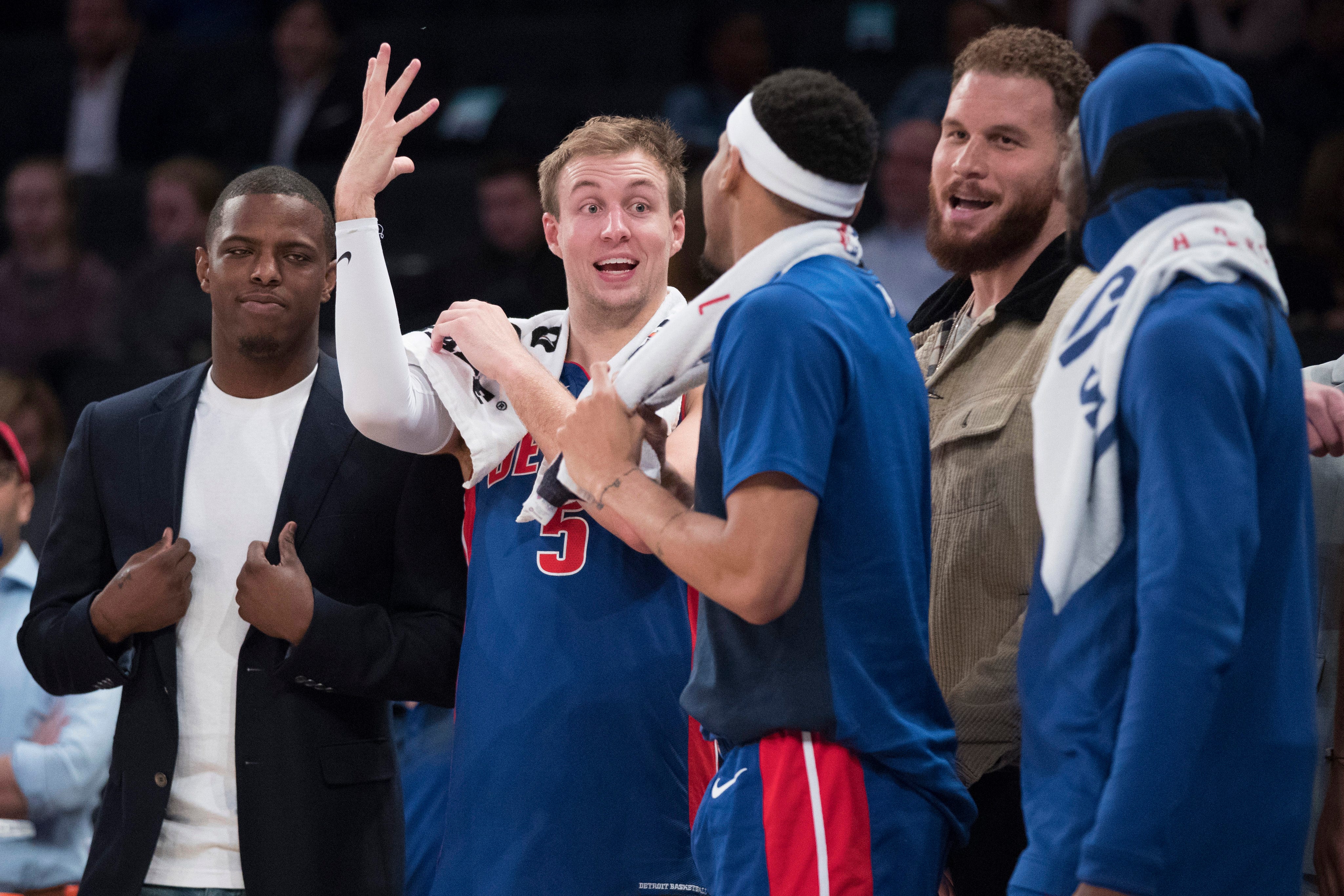 Detroit Pistons guard Luke Kennard (5) celebrates with teammates at the bench in the final seconds of the game.