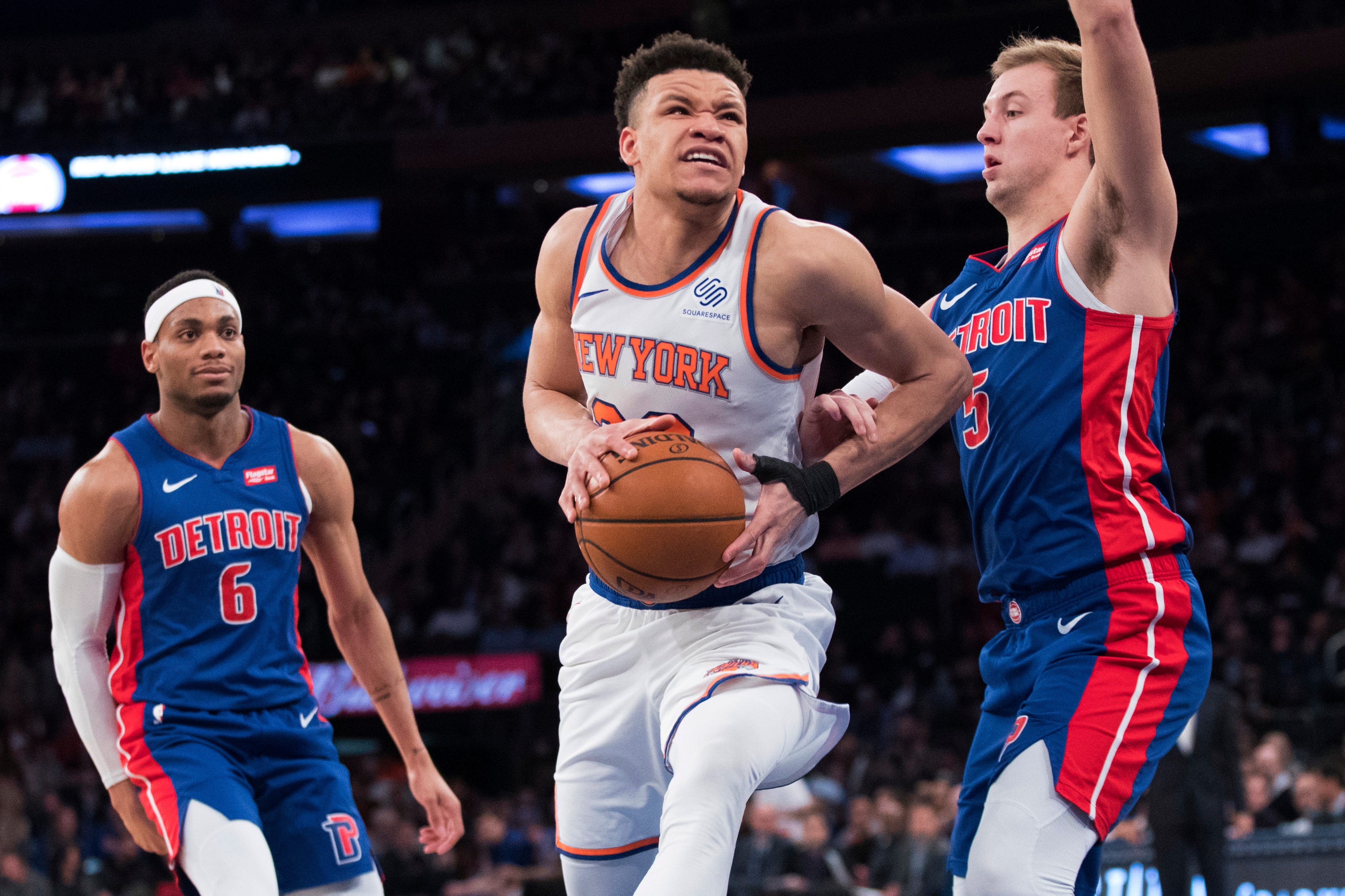 New York Knicks forward Kevin Knox, center, goes to the basket against Detroit Pistons guard Luke Kennard (5) during the second half.