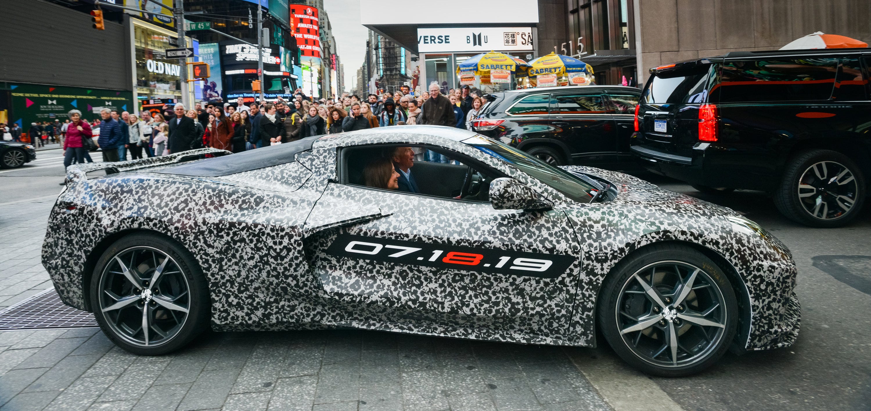 Chevrolet Corvette Chief Engineer Tadge Juechter and General Motors Chairman and CEO Mary Barra drive in a camouflaged next generation Corvette down 7th Avenue near Times Square Thursday, April 11, 2019 in New York City.
