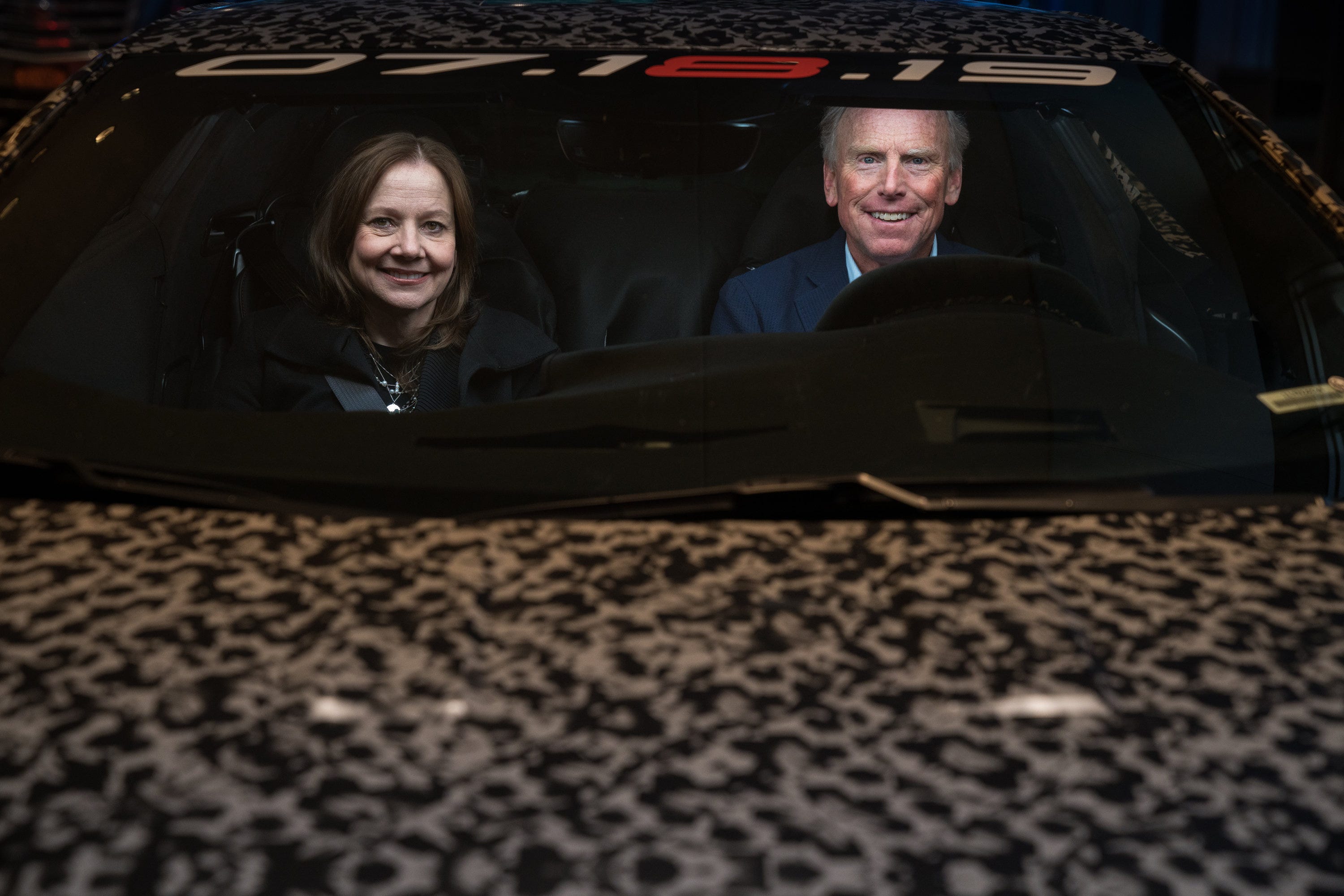 General Motors Chairman and CEO Mary Barra and Corvette Chief Engineer Tadge Juechter inside a camouflaged next generation Chevrolet Corvette.