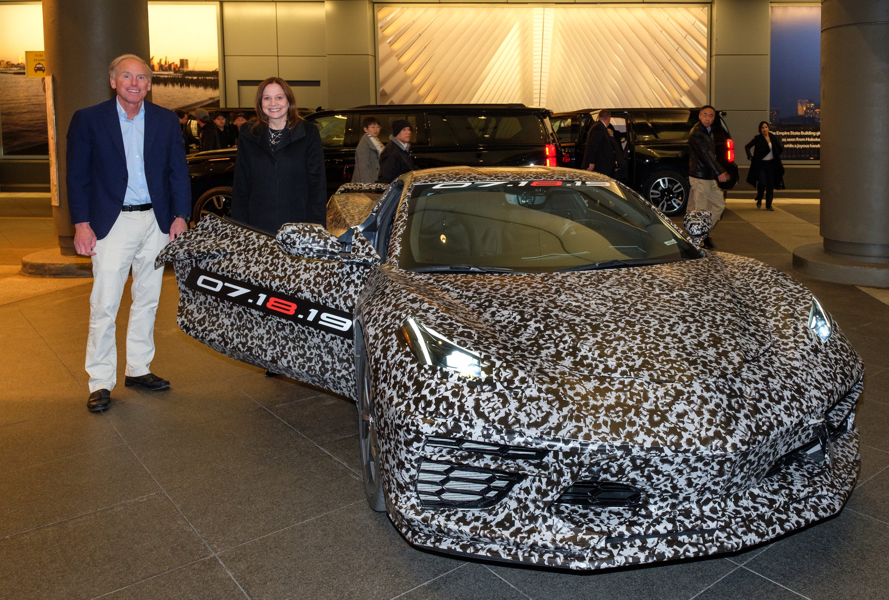 Chevrolet Corvette Chief Engineer Tadge Juechter and General Motors Chairman and CEO Mary Barra Thursday, April 11, 2019 with a camouflaged next generation Corvette near Times Square in New York City.