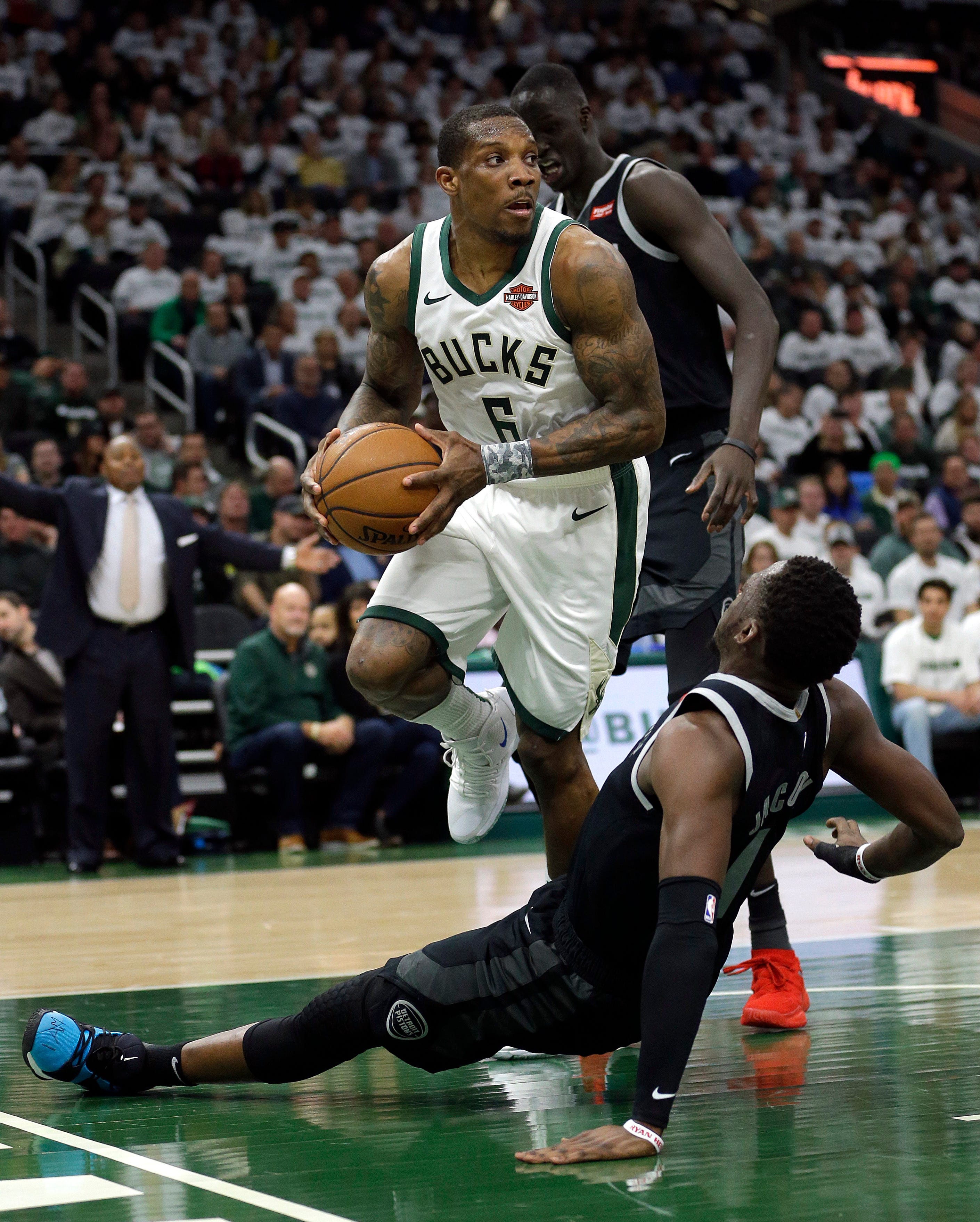 Pistons ' Reggie Jackson falls to the floor while defending Bucks ' Eric Bledsoe during the second half.