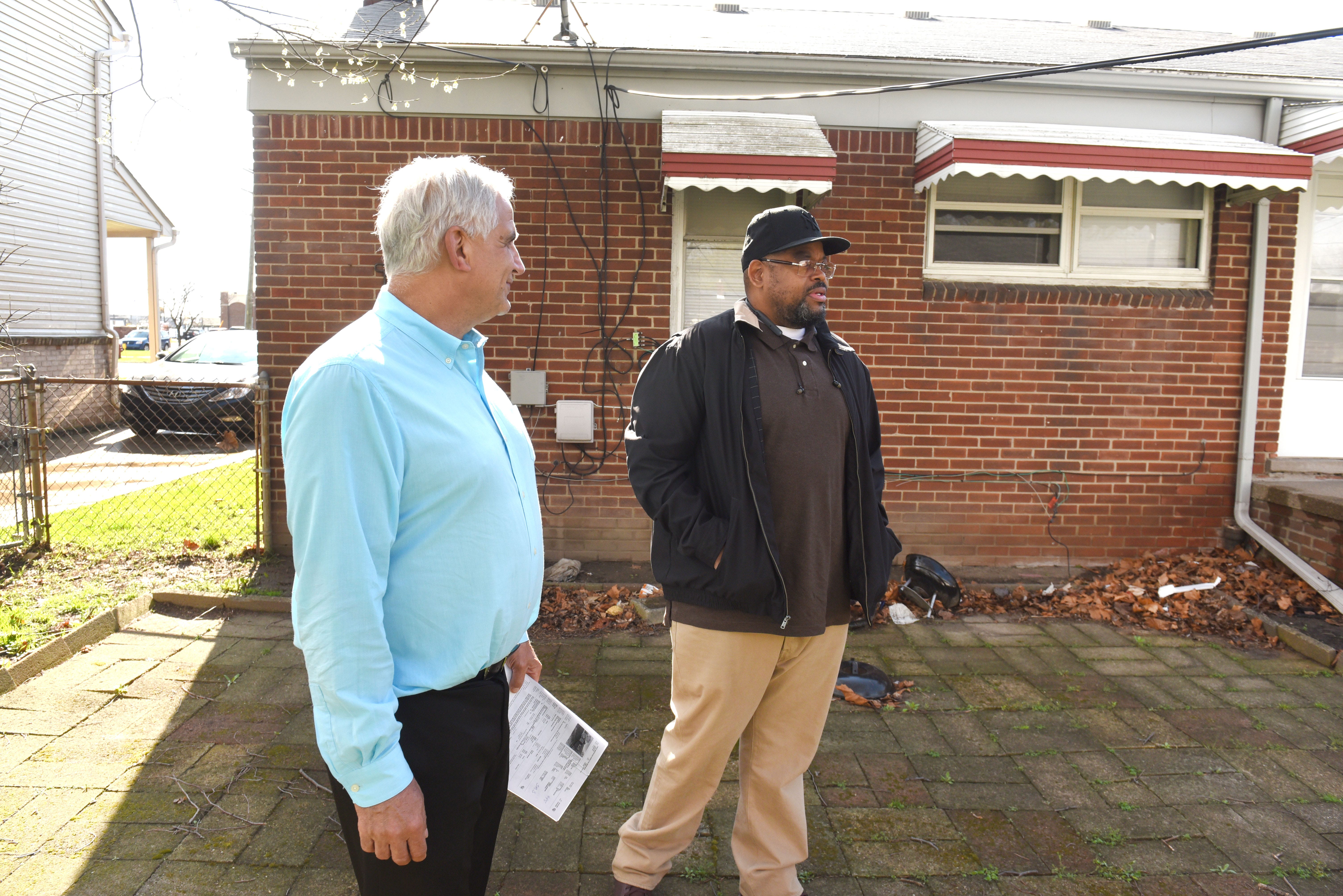 Real Estate One agent Russ Ravary, left, shows a house for sale in Redford Township to Jerome DuBose of Detroit on April 26.  A tight housing market in recent years has driven up single-family prices by more than 70% since 2012 statewide.