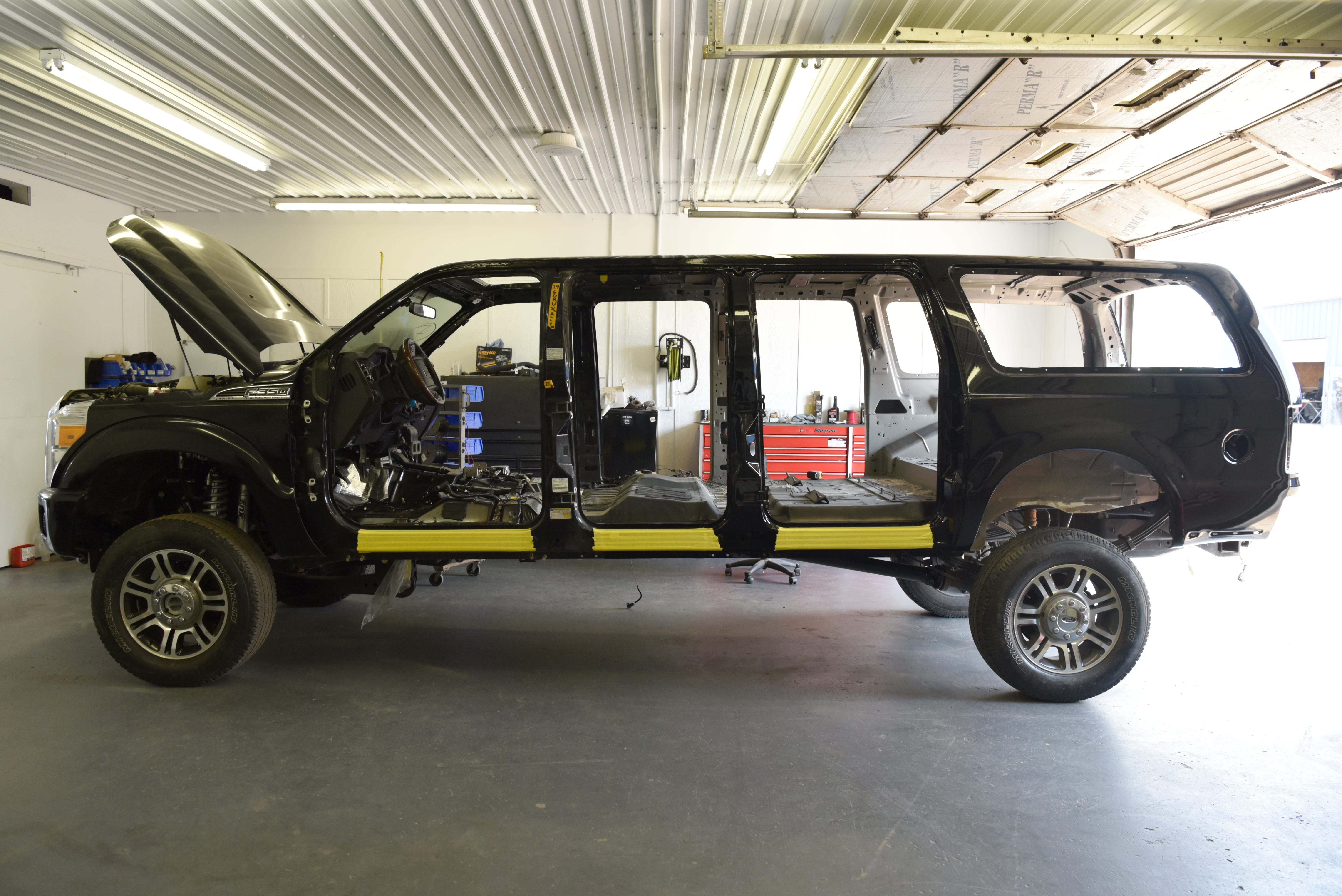 A custom six-door Ford Excursion waits to be outfitted with an interior at Custom Autos By Tim in Guthrie, Oklahoma.