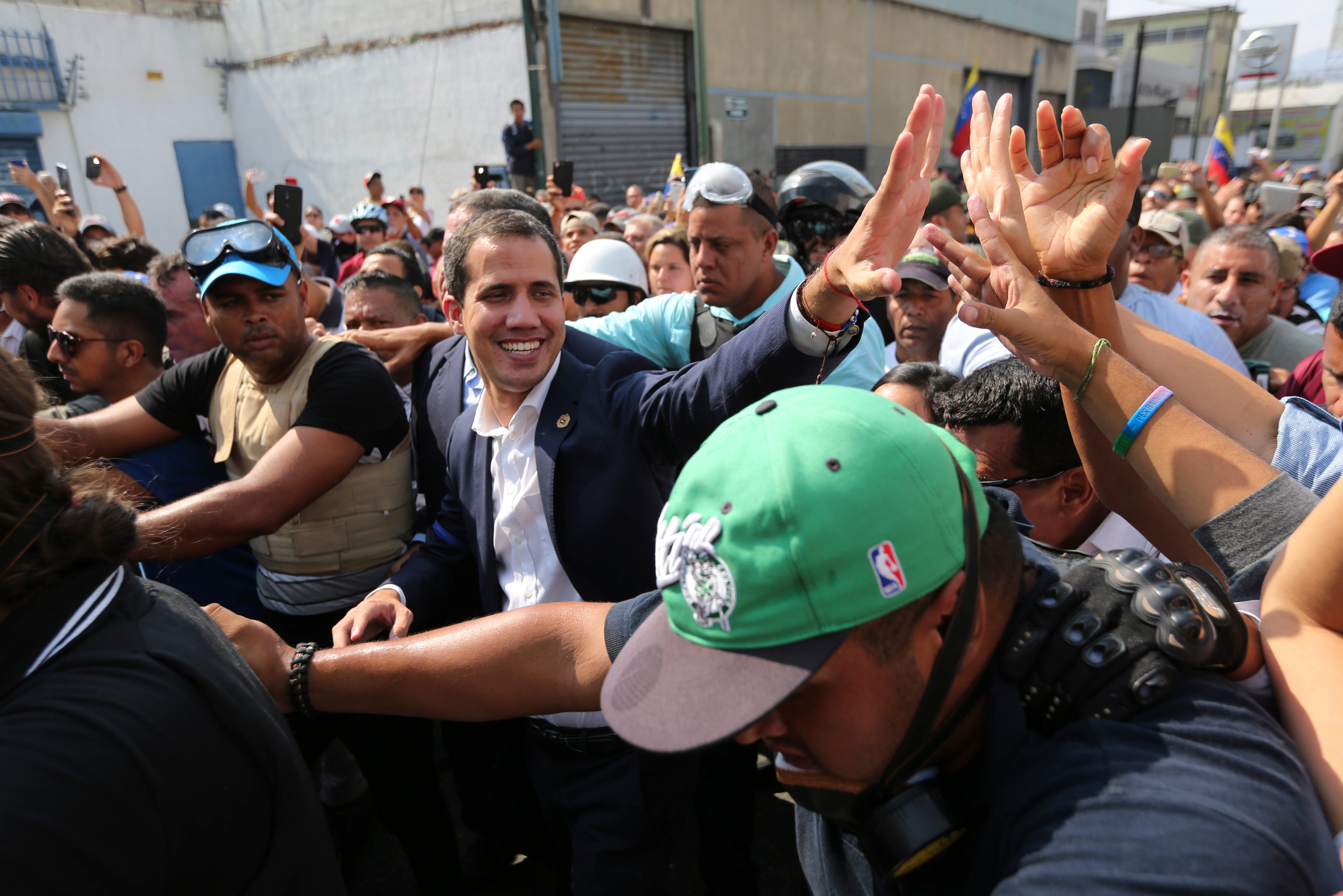 Venezuela's self-proclaimed president Juan Guaido greets supporters in Caracas, Venezuela, Tuesday, April 30, 2019. Guaido has taken to the streets with a small contingent of heavily armed troops early Tuesday in a bold and risky call for the military to rise up and oust President Nicolas Maduro.