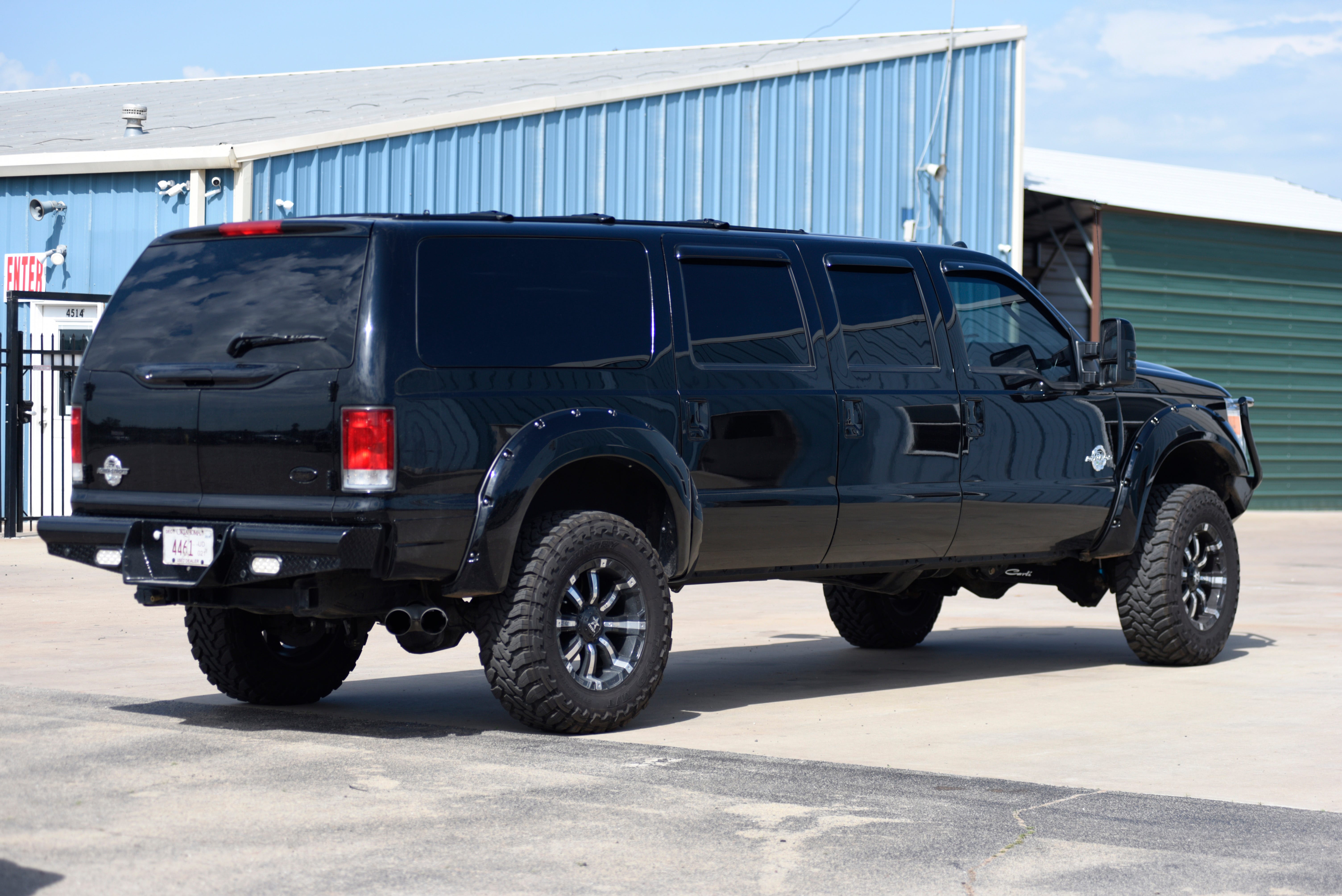 A custom built six-door Ford Excursion sits in the lot at  Custom Autos By Tim in Guthrie, Oklahoma.