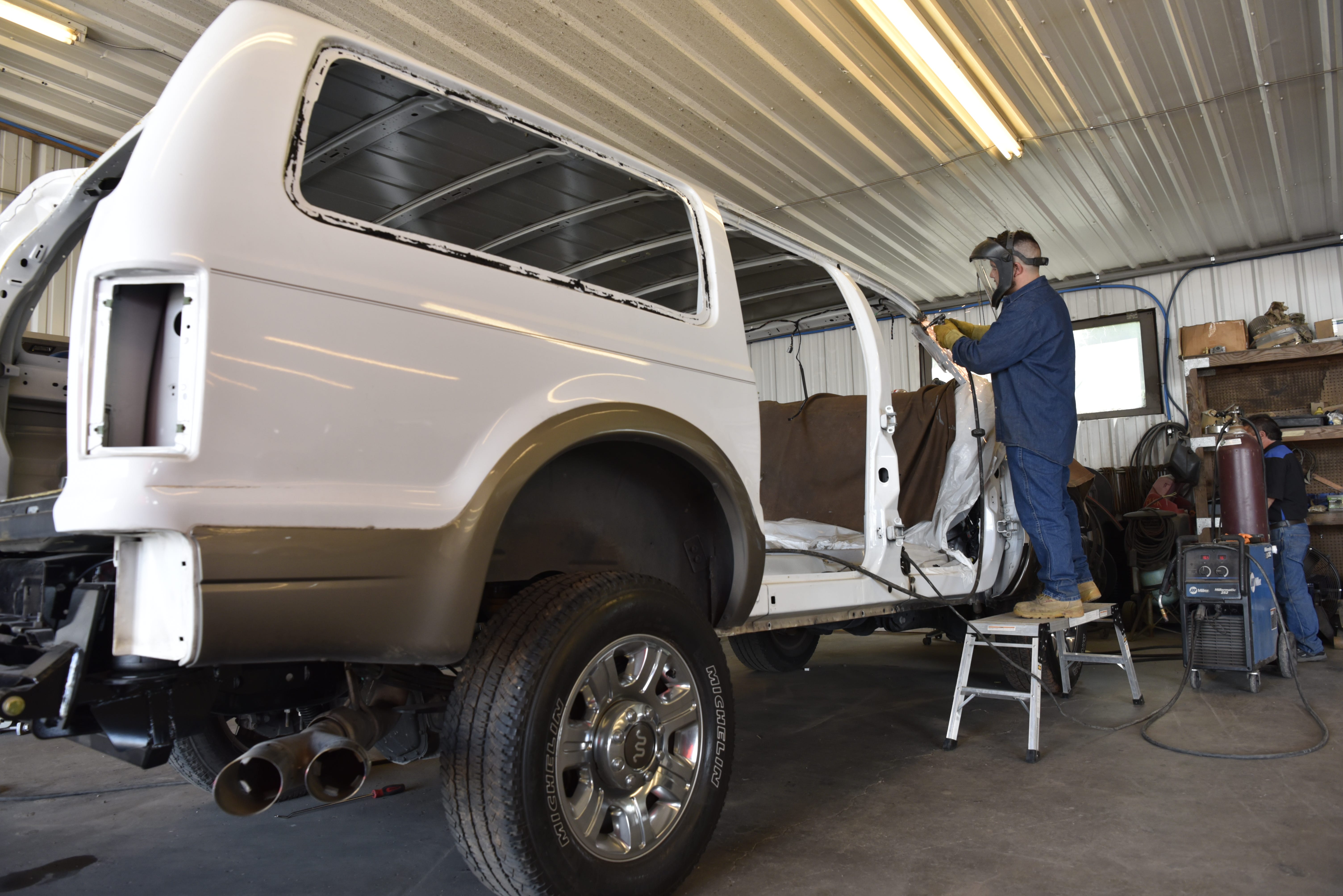 Alex Sanchez grinds a weld on a custom built Ford Excursion at Custom Autos By Tim in Guthrie, Oklahoma.
