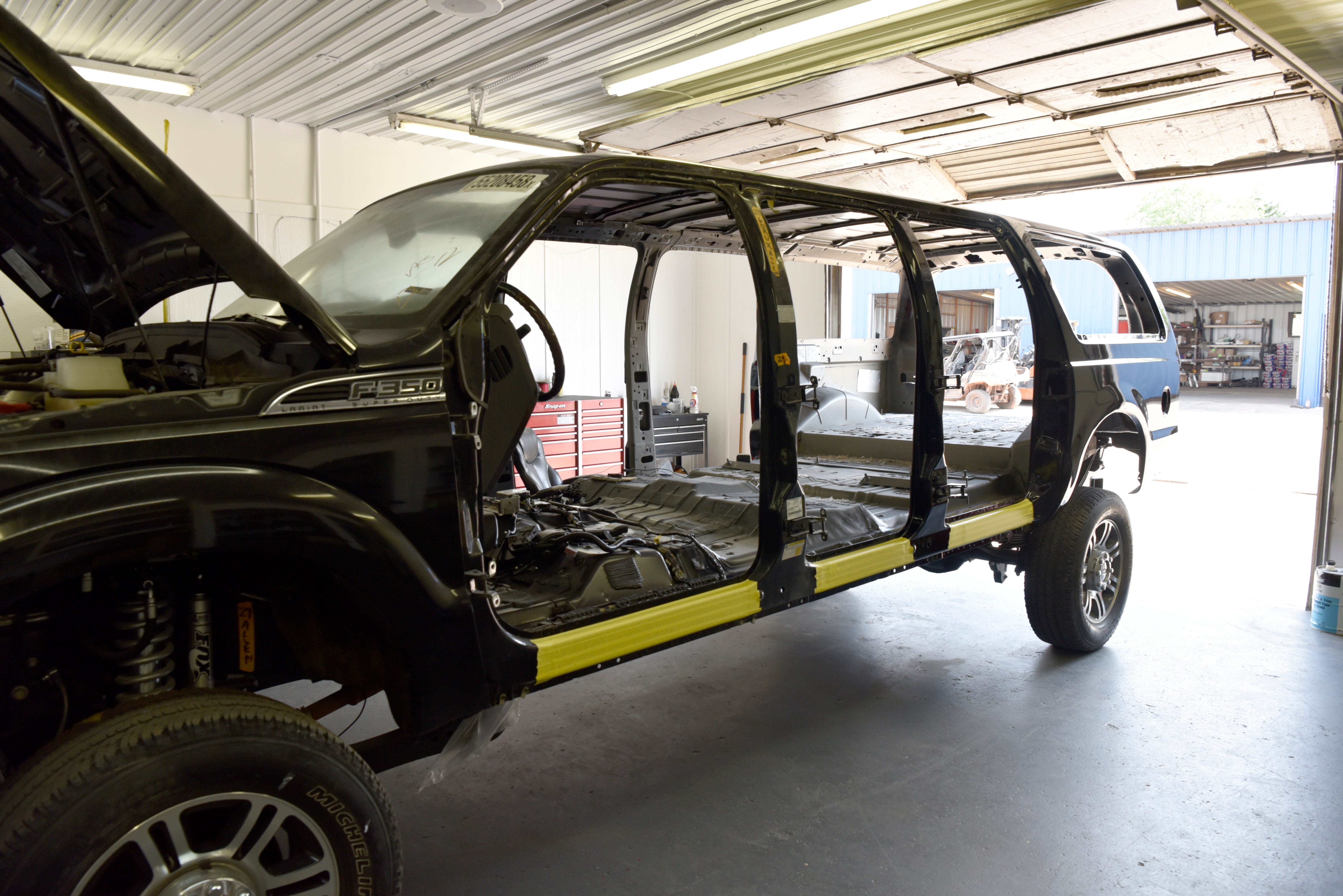 A custom six door Ford Excursion waits to be outfitted with an interior.