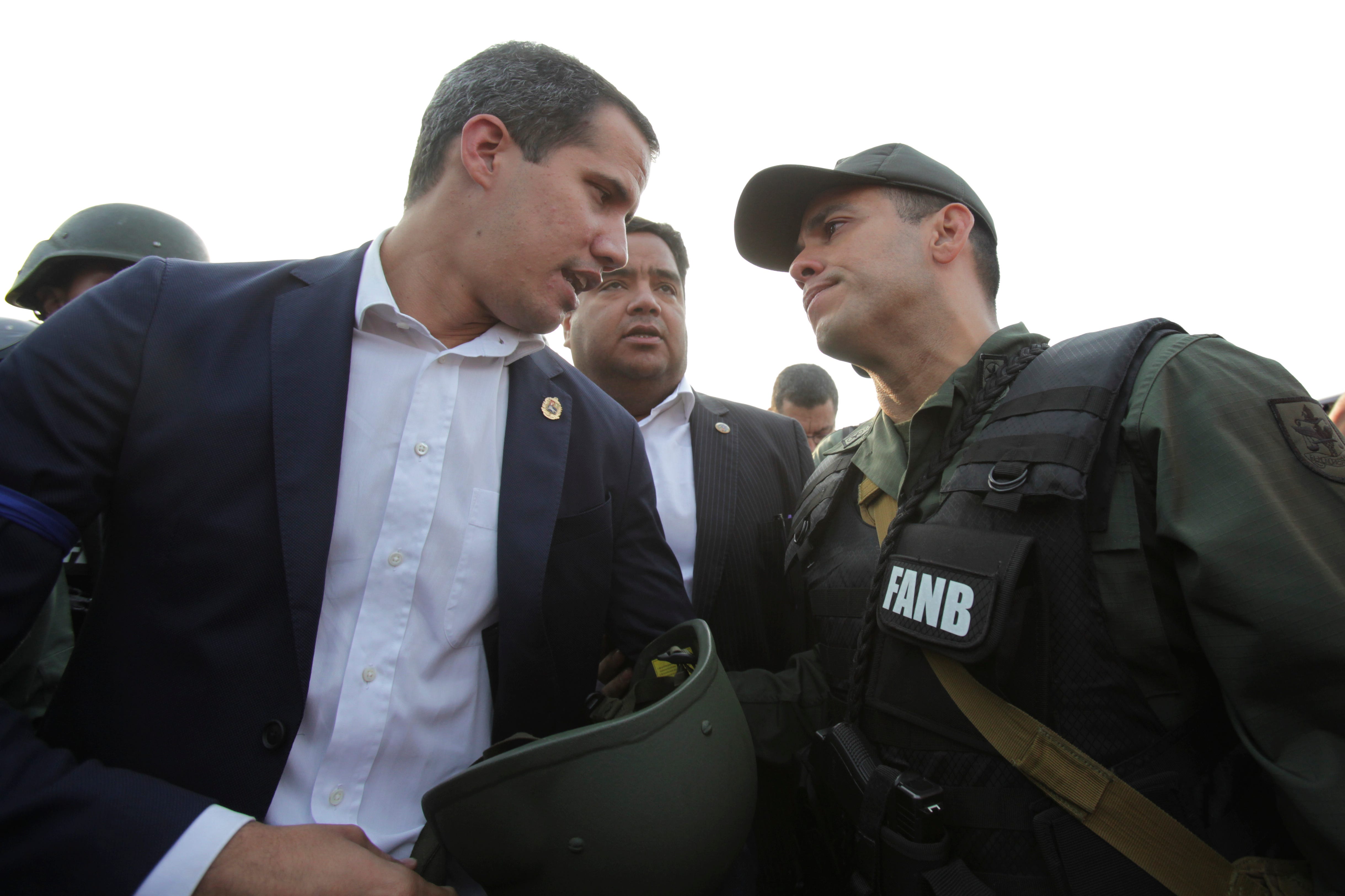 Venezuela ' s opposition leader and self proclaimed president Juan Guaido talks to an Army officer outside La Carlota air base in Caracas, Venezuela, April 30, 2019.
