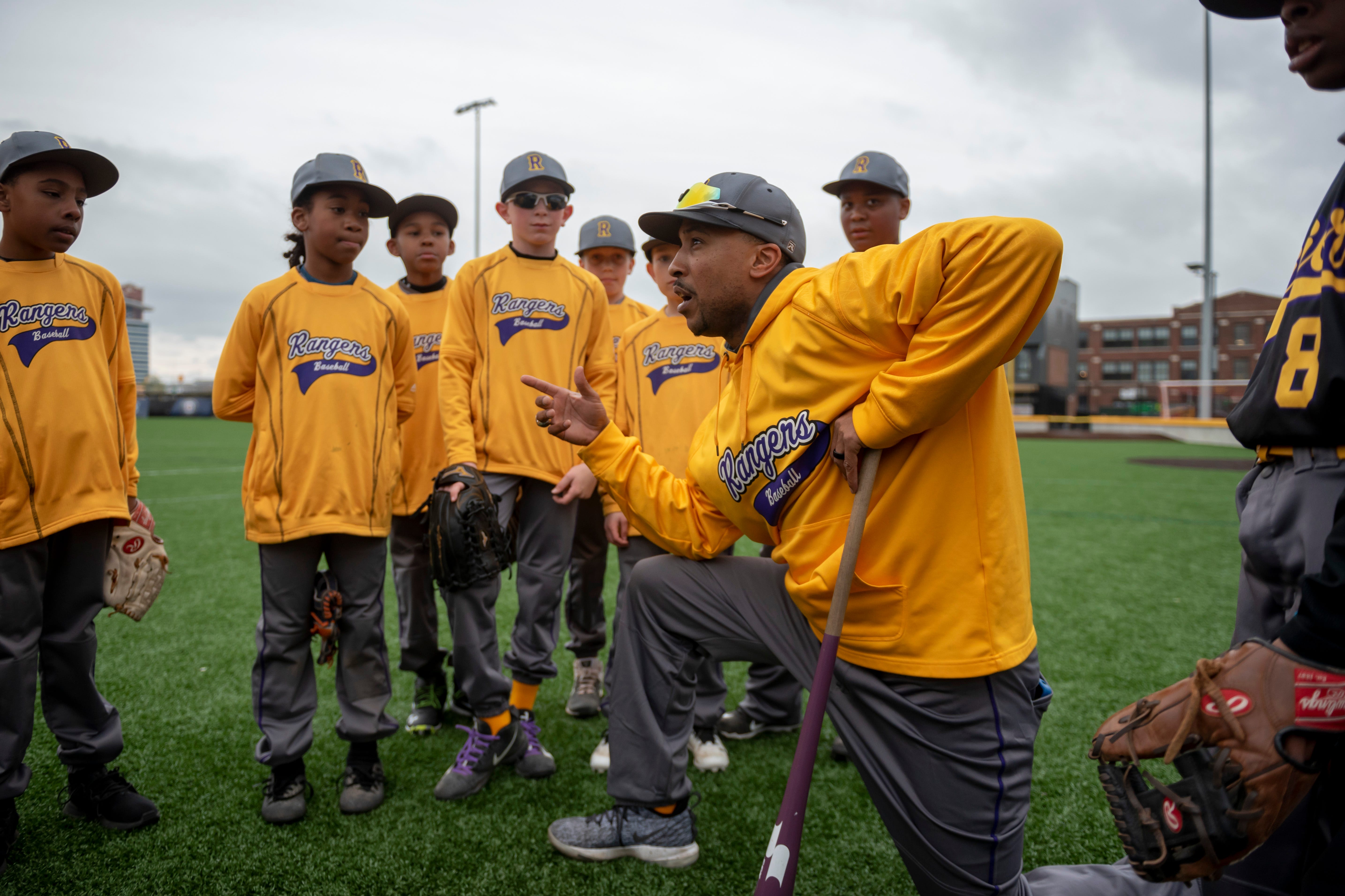 Dytarious Edwards, coach of the 11U Detroit Rangers, talks with his team before a Police Athletic League scrimmage in 2019 against the YMCA Tigers at The Corner Ballpark.