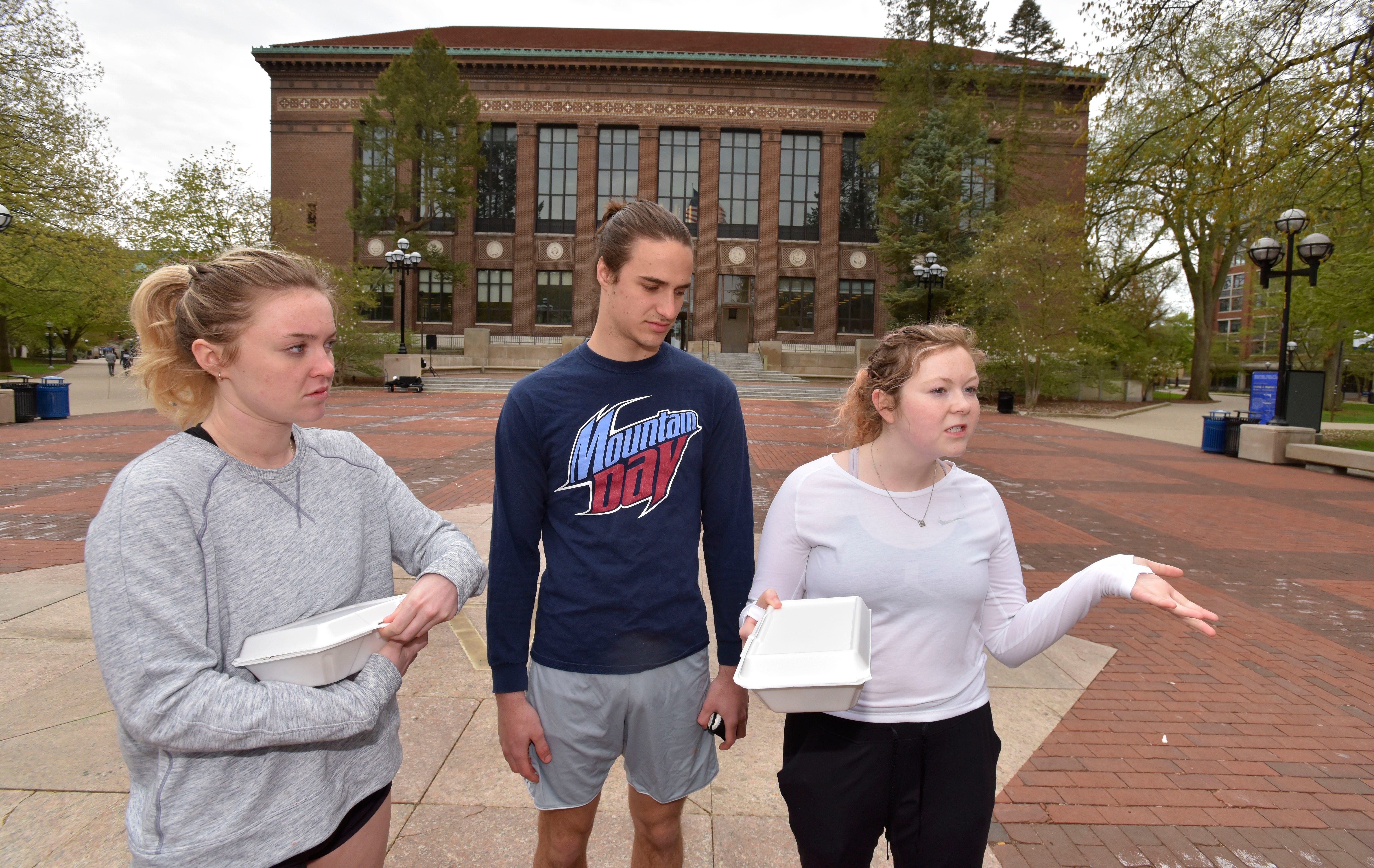 Grace Fanning, left, of New Jersey, Jason Knopf, of the Chicago area and Meg Wynne, of Indianapolis, talk about school debt on the Diag on the main campus of the University of Michigan in Ann Arbor.