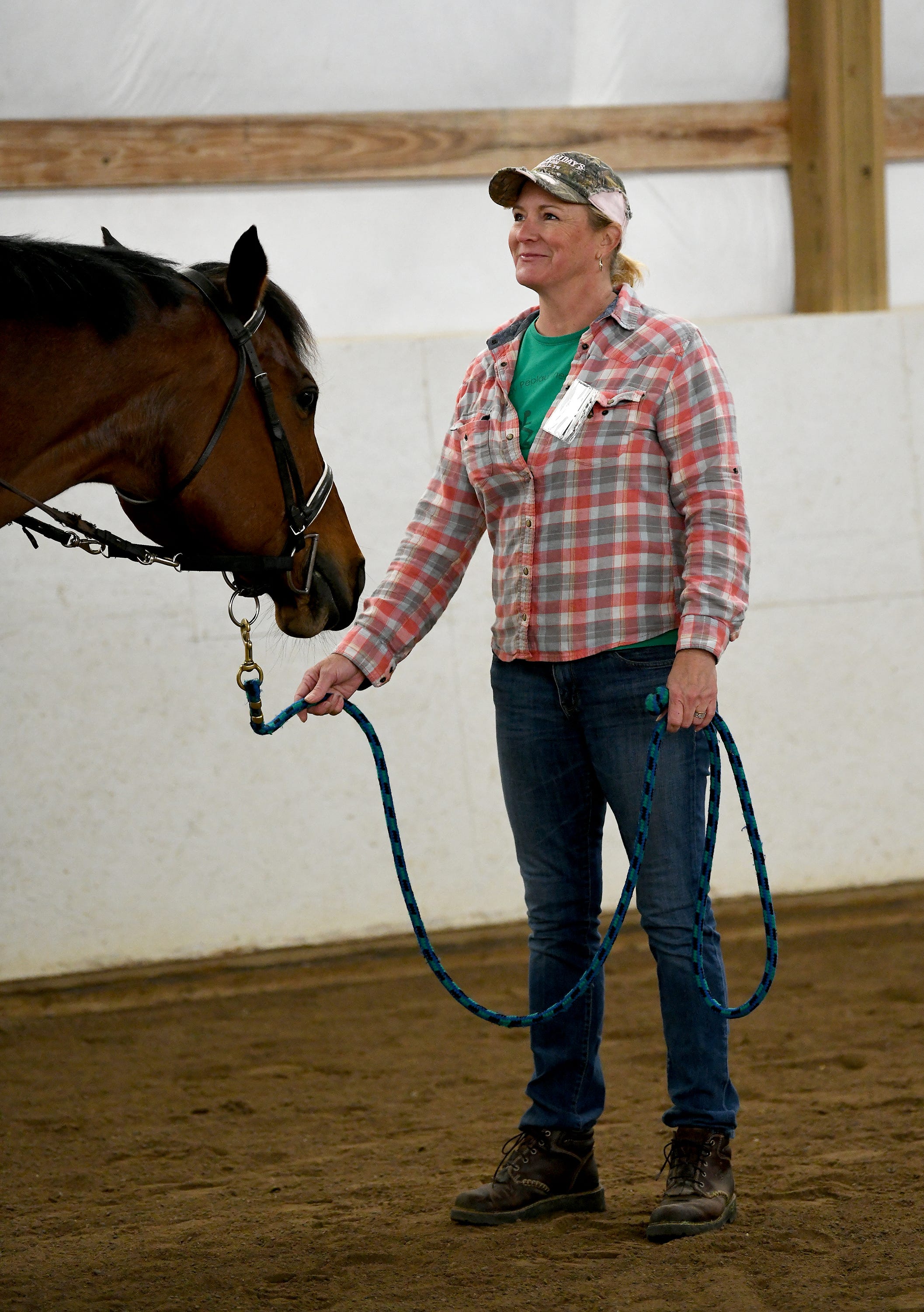 Volunteer Angela Bonnell, helps out with the horse B. Smiley, during the Tuesday morning riding session at Therapeutic Riding Inc. in Ann Arbor.