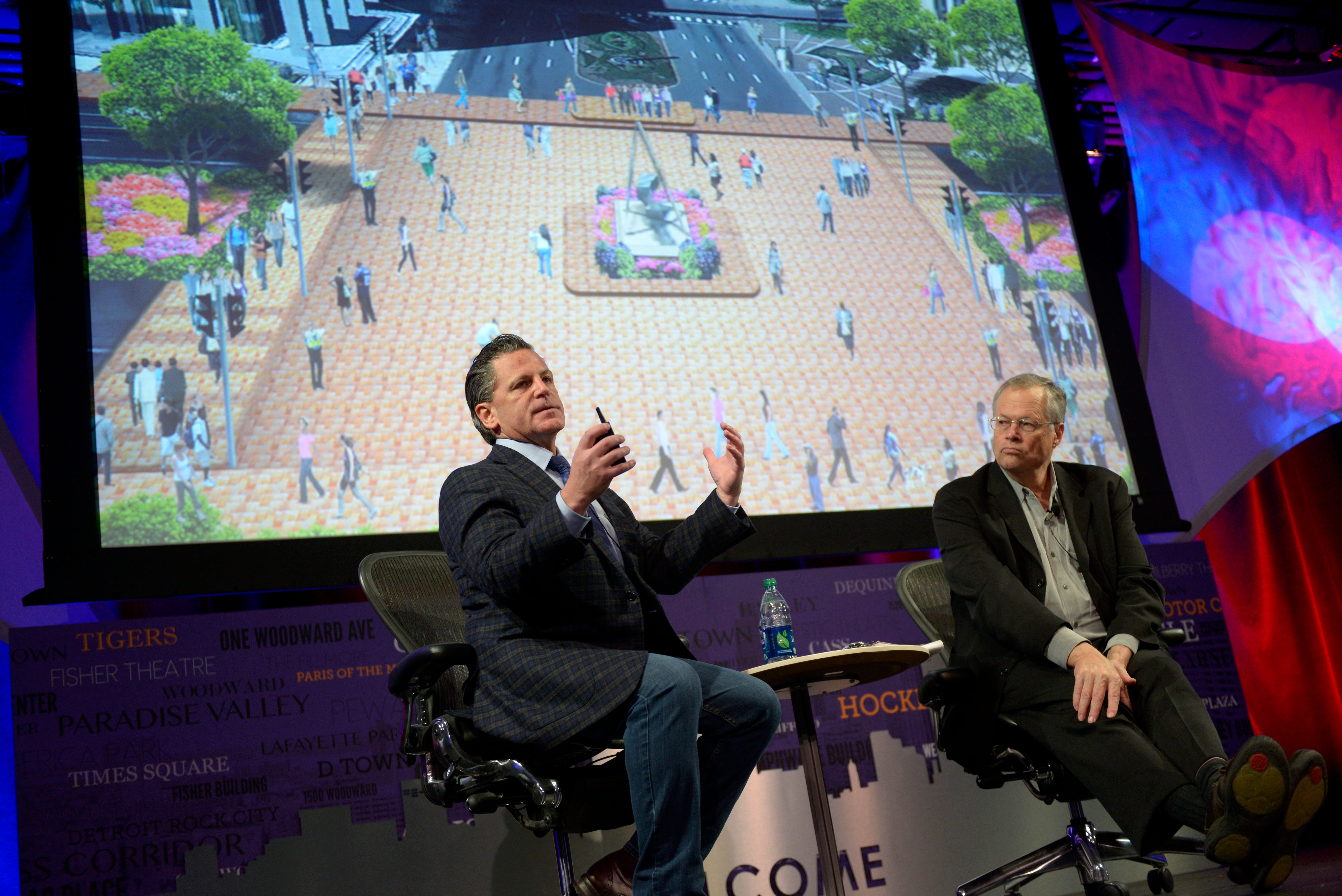 Dan Gilbert, chairman and founder of Quicken Loans Inc., left, and Fred Kent, President of the Project for Public Spaces, talk about proposed improvements to downtown Detroit, including this mock-up of the intersection of Woodward and Jefferson, at the City Theatre in Detroit, March 28, 2013.