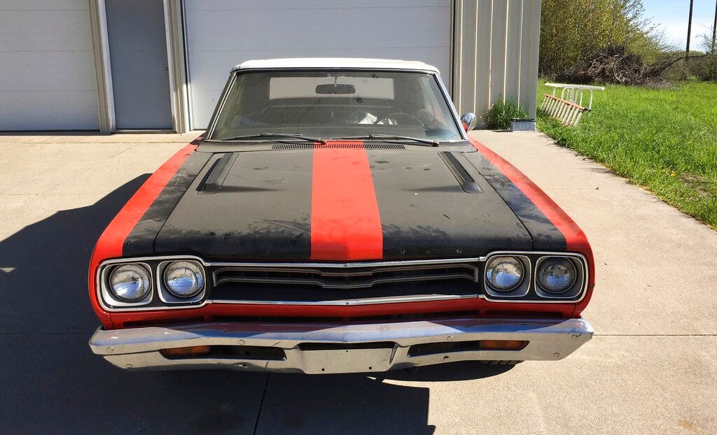 In a May 21, 2019 handout photo from the Leelanau County Sheriff, a 1969 Plymouth GTX convertible is seen. The sheriff's office is auctioning some rare muscle. Undersheriff Steve Morgan says the car probably was stored for decades and the odometer shows less than 21,000 miles. The car was abandoned in a storage building that has changed hands a few times, northwest of Traverse City. Morgan says investigators searched the vehicle's identification number but couldn't find an owner.