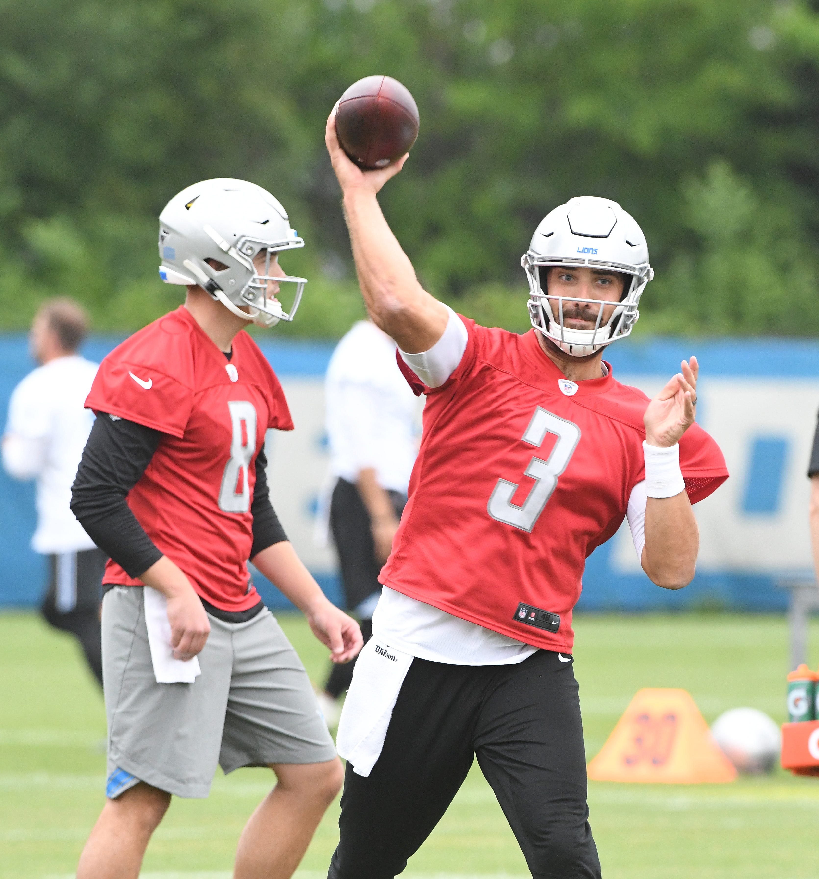Lions quarterback Tom Savage with David Fales in background during drills.