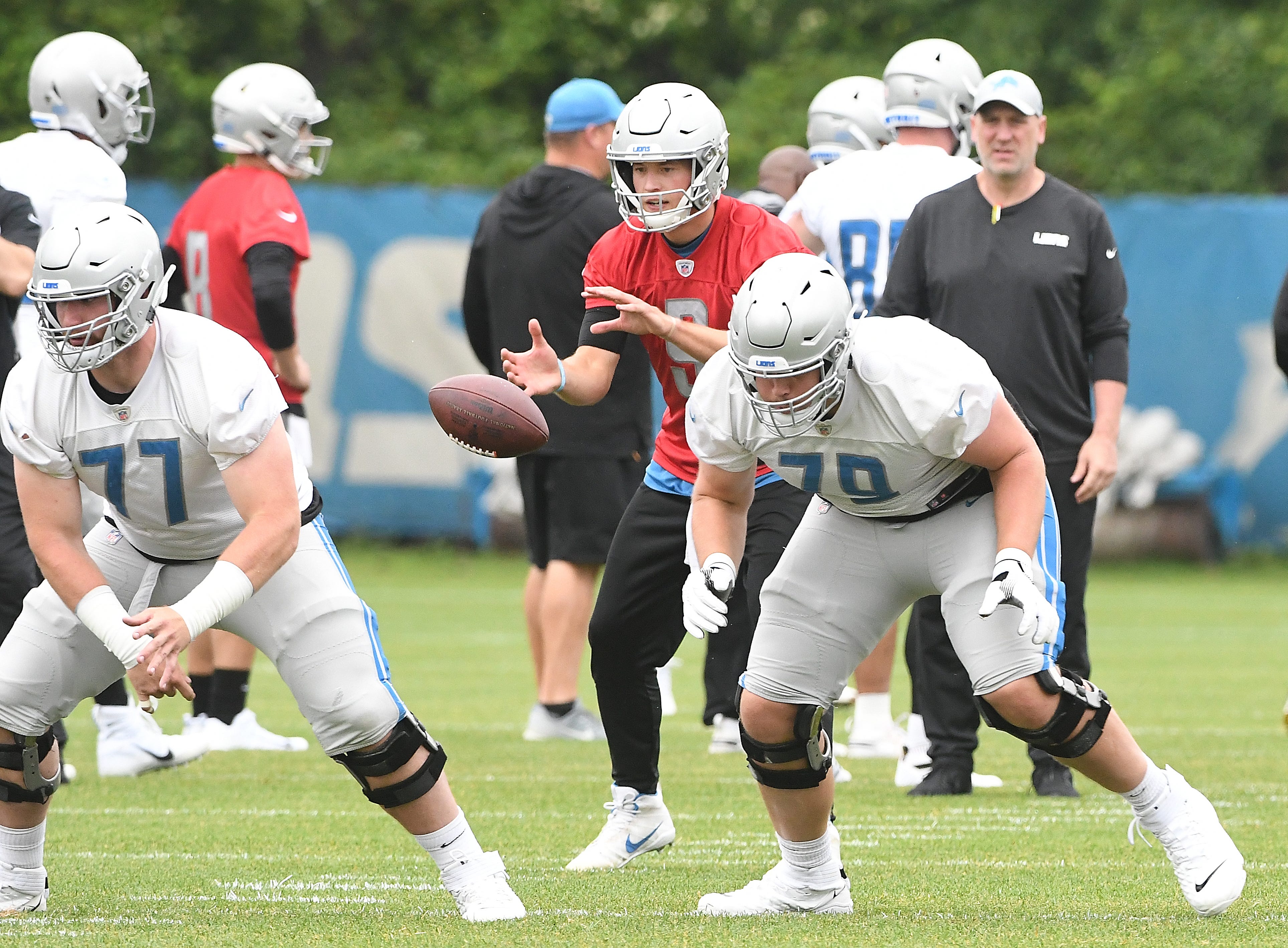 Lions quarterback Matthew Stafford in the pocket behind linemen Frank Ragnow and Kenny Wiggins during drills.
