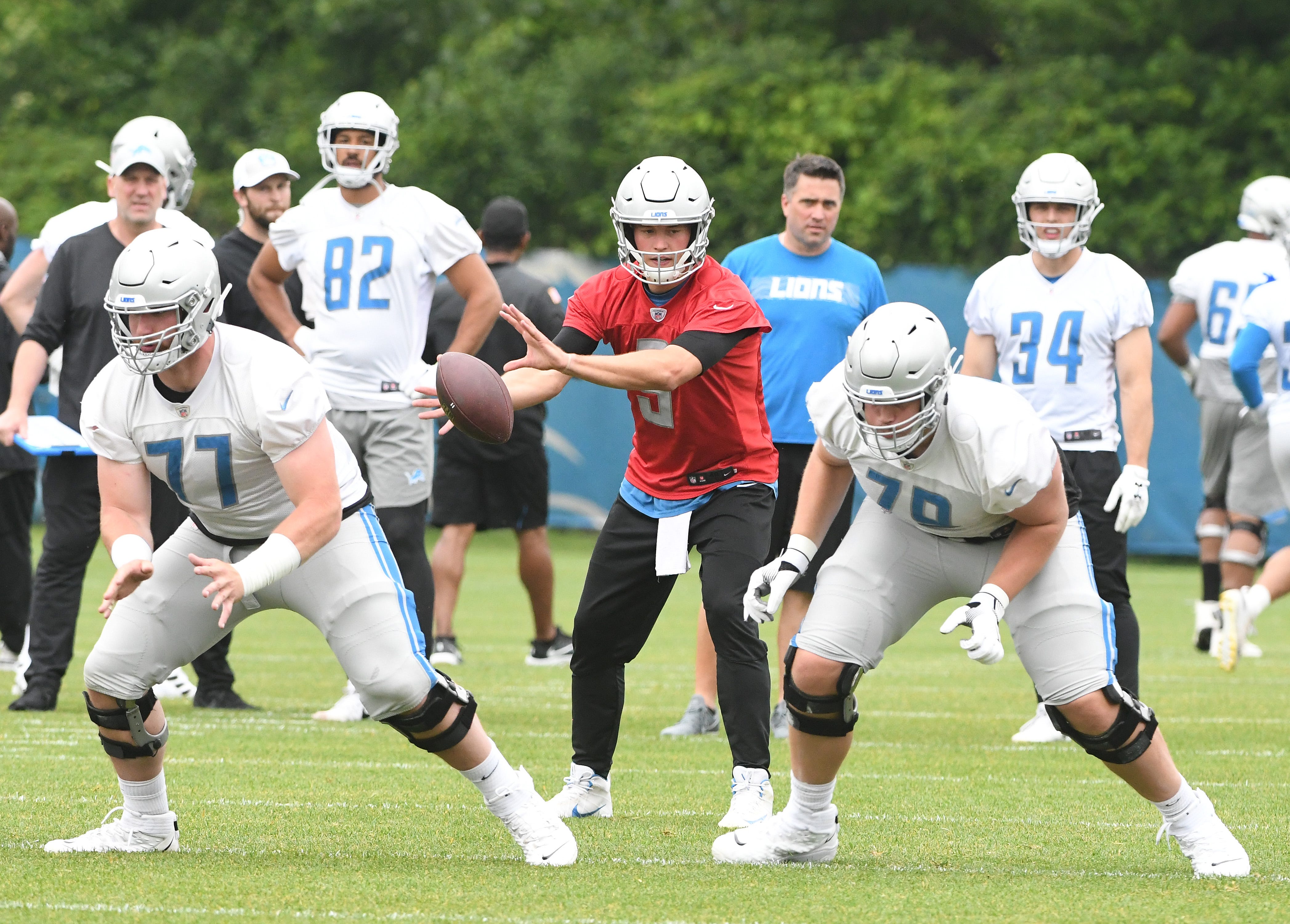 Lions quarterback Matthew Stafford in the pocket behind linemen Frank Ragnow and Kenny Wiggins during drills.