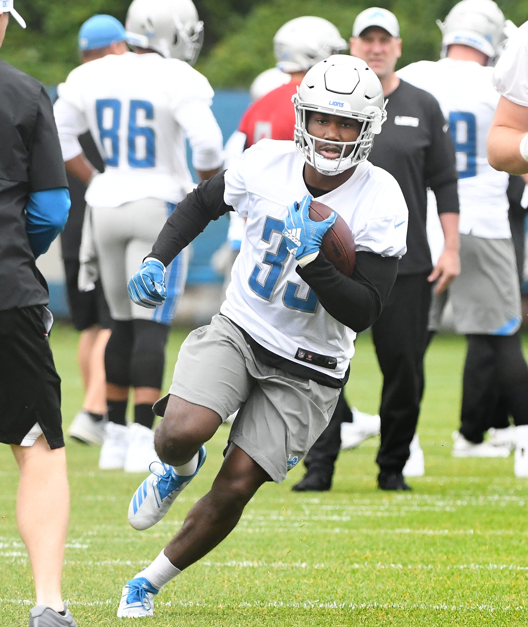 Lions running back Kerryon Johnson cuts up field during drills.
