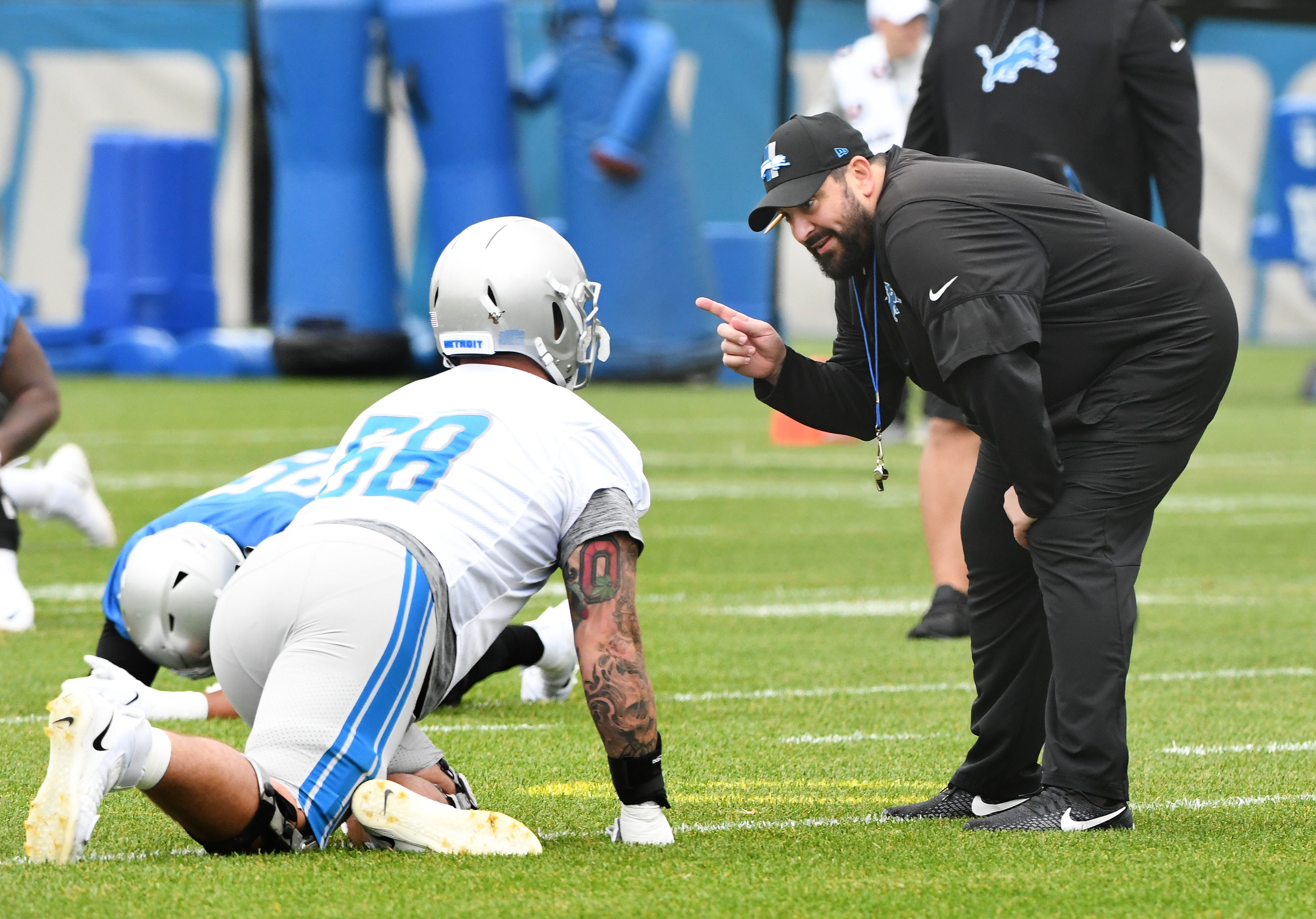 Lions tackle Taylor Decker talks with head coach Matt Patricia during warmups on Thursday, June 13.