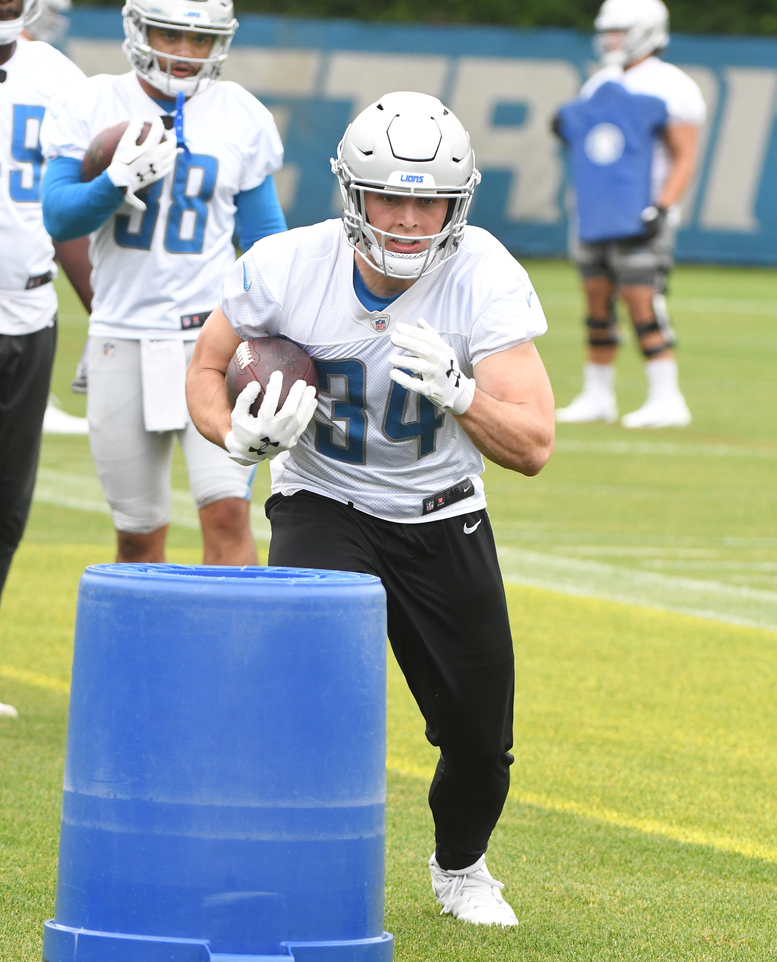 Lions running back Zach Zenner cuts around the obstacles during drills.