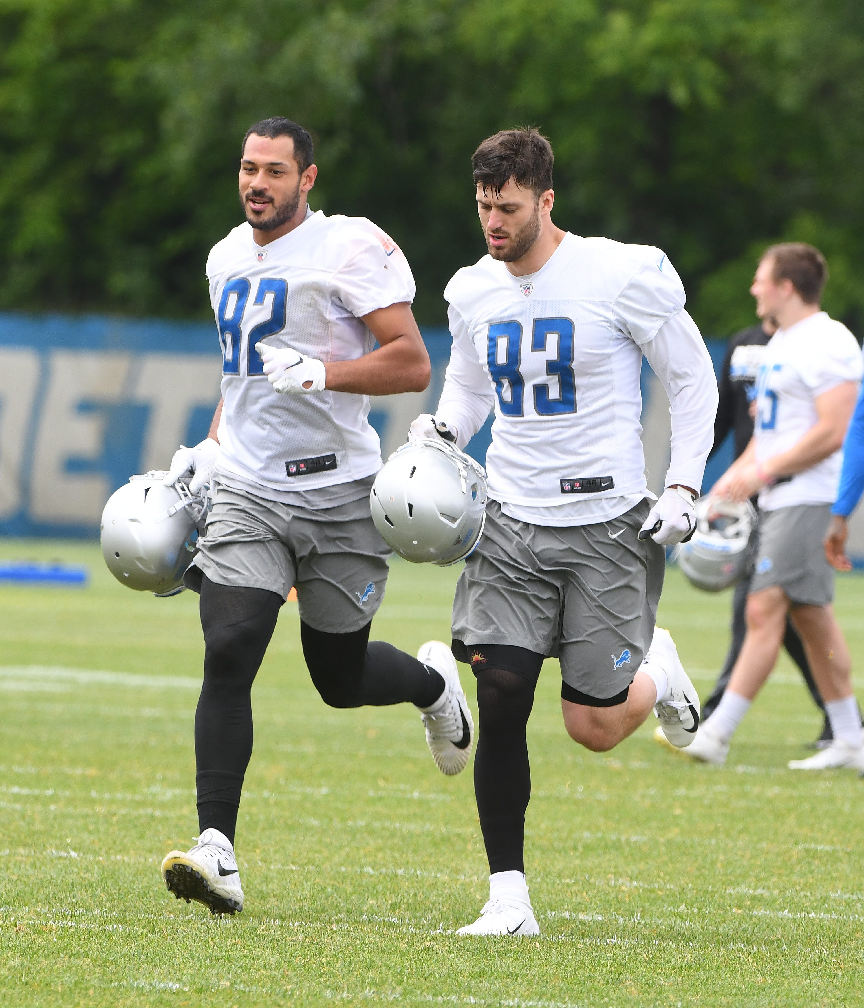 Lions tight ends Logan Thomas and Jesse James run off the field at the end of practice.