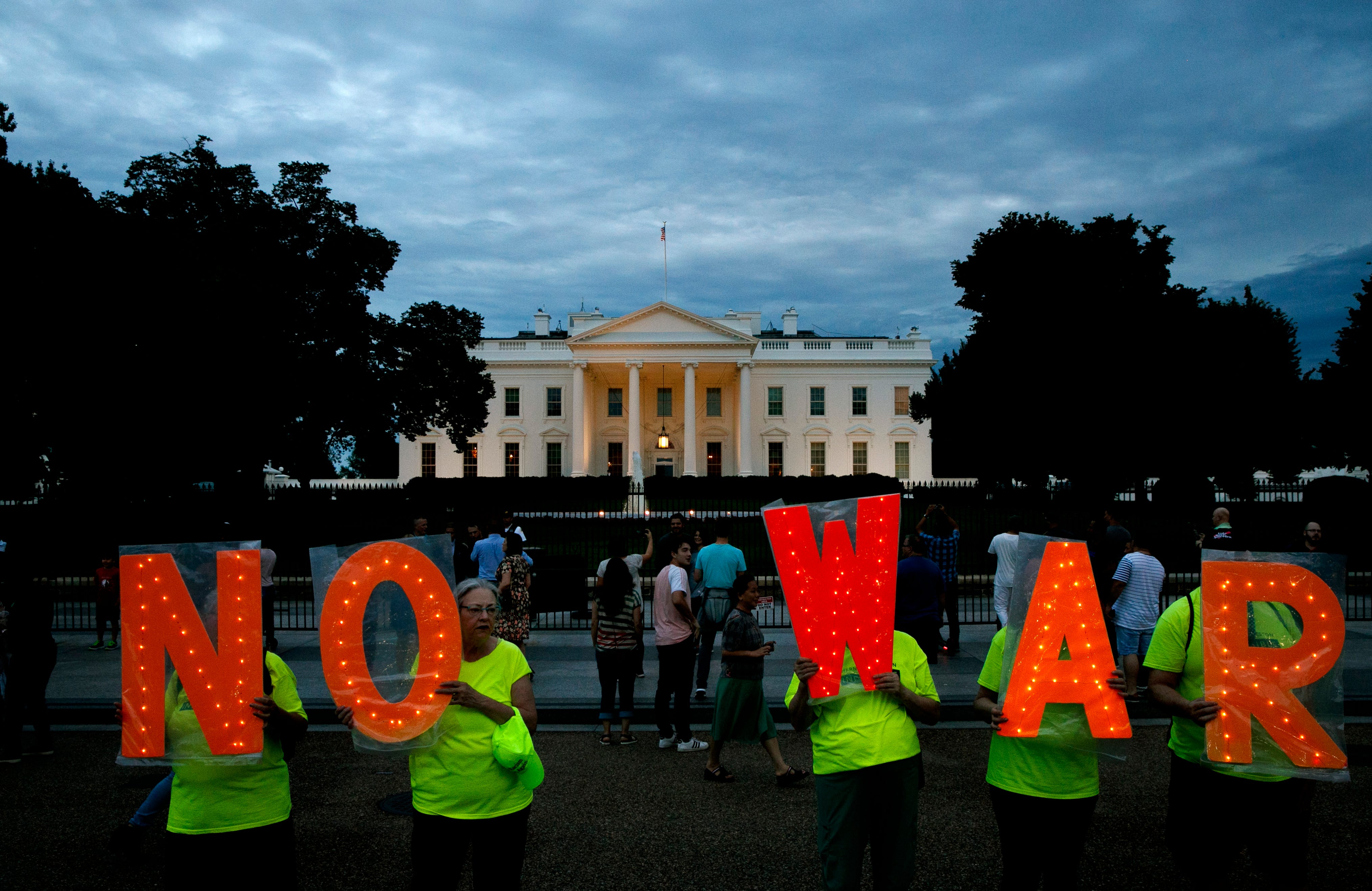 Protesters outside the White House, Thursday June 20, 2019, in Washington, after President Donald Trump tweeted that "Iran made a very big mistake" by shooting down a U.S. surveillance drone over the Strait of Hormuz in Iran.