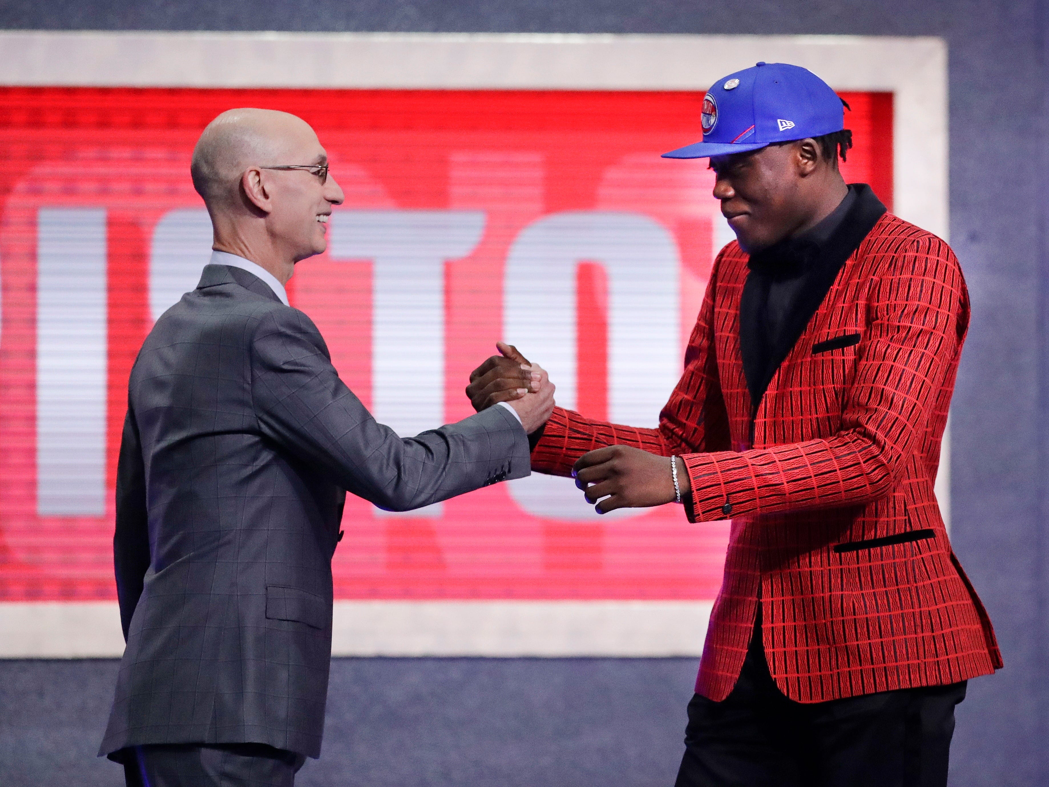 NBA Commissioner Adam Silver greets Sekou Doumbouya after the Detroit Pistons selected him as the 15th pick overall.