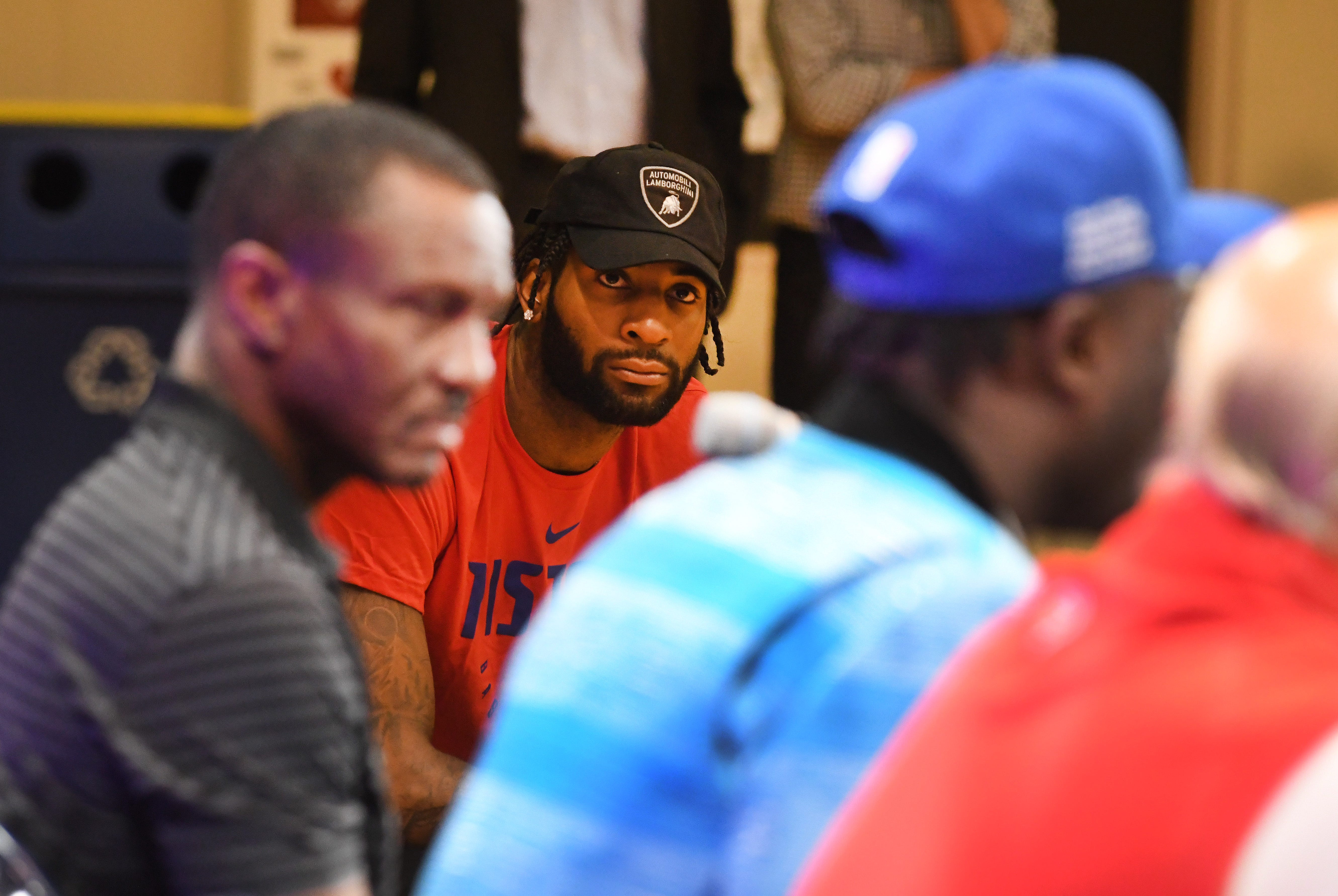Pistons center Andre Drummond, rear, listens to first round draft pick Sekou Doumbouya's press conference.