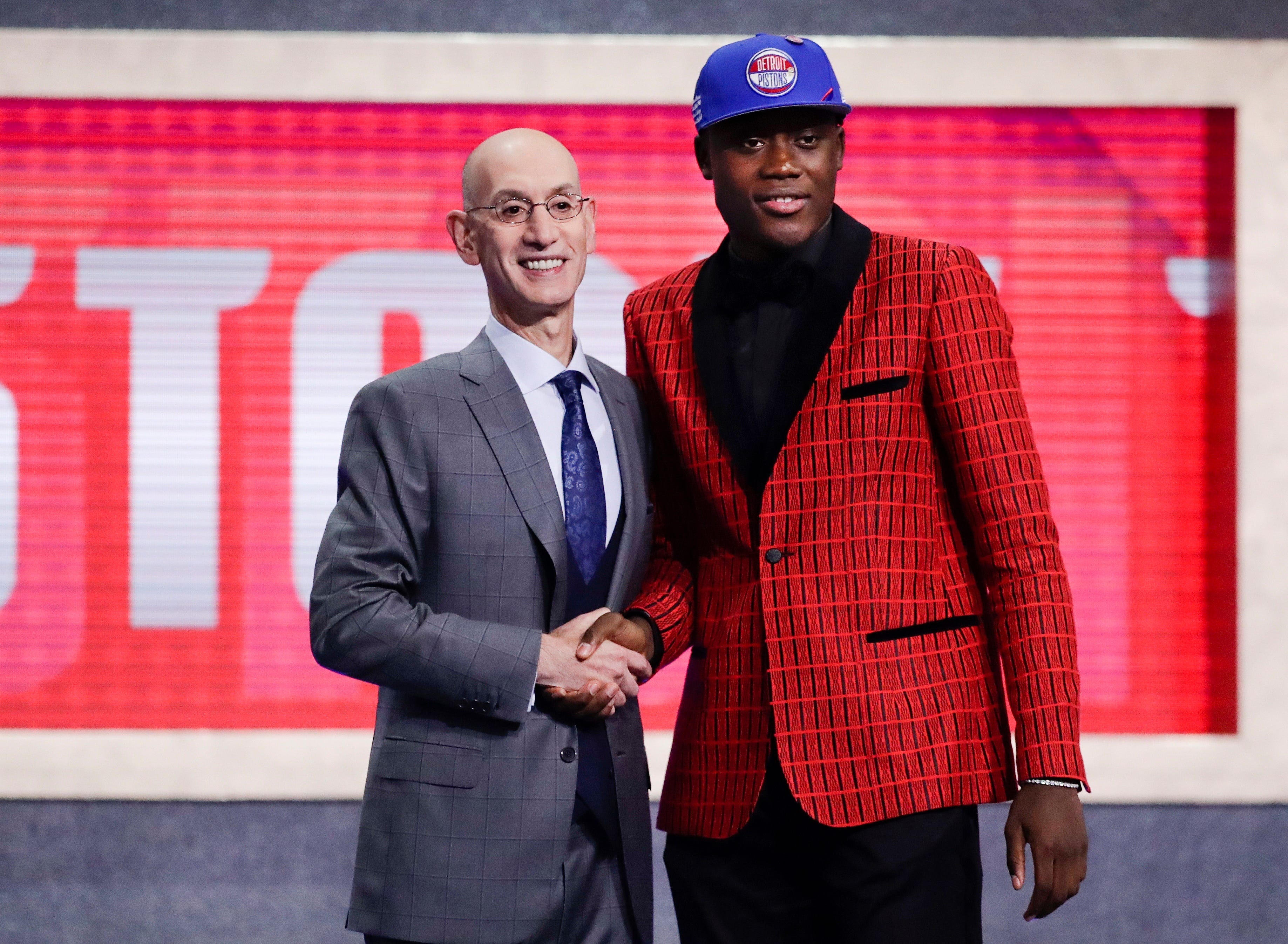 NBA Commissioner Adam Silver poses for photographs with Sekou Doumbouya after the Detroit Pistons selected him.