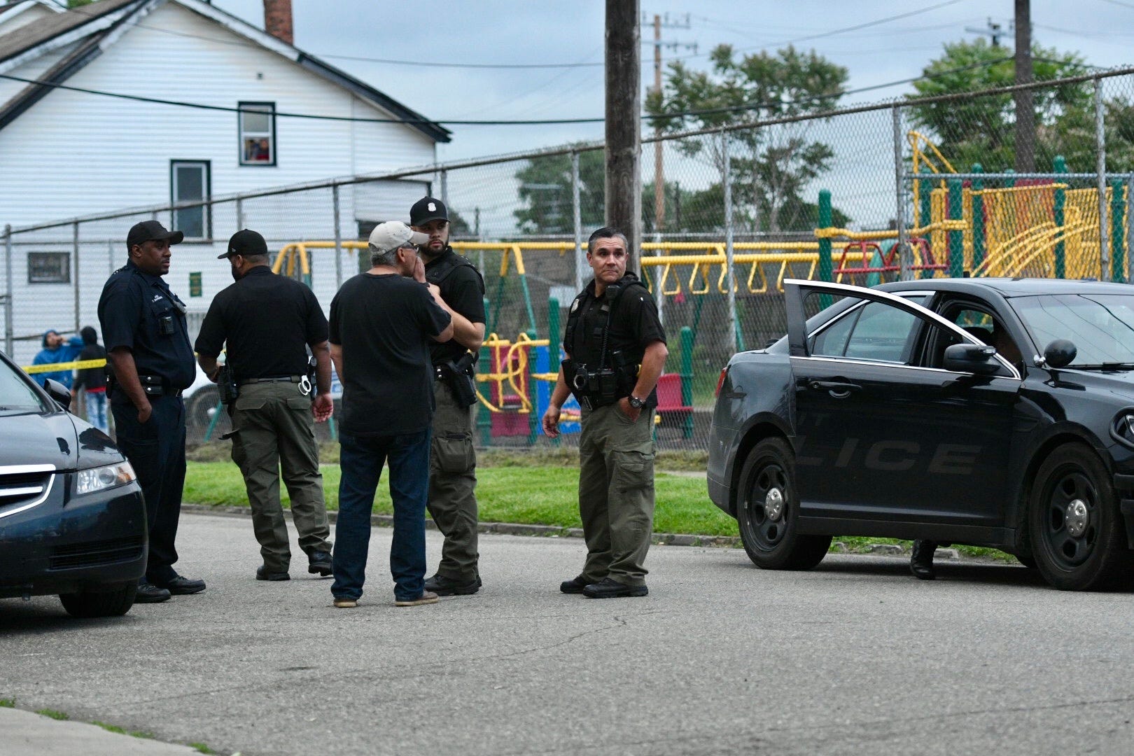 Detroit police gather on Honorah Street in Detroit during an investigation of a fatal shooting. A teen was shot during an exchange between the teen and suspect, who was fatally shot Thursday evening.